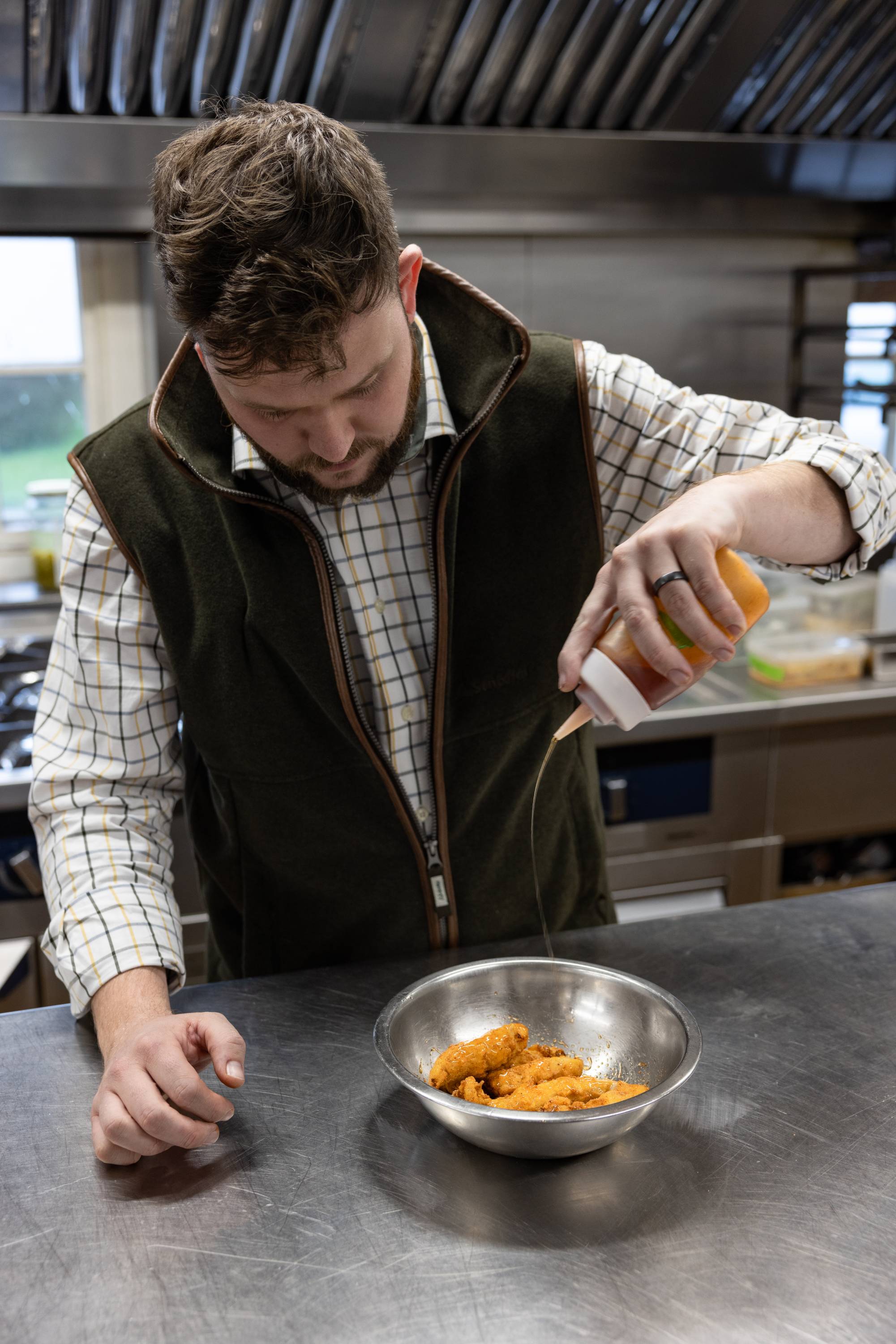 Callum drizzles local runny honey and fermented chilli powder over the pheasant goujons.