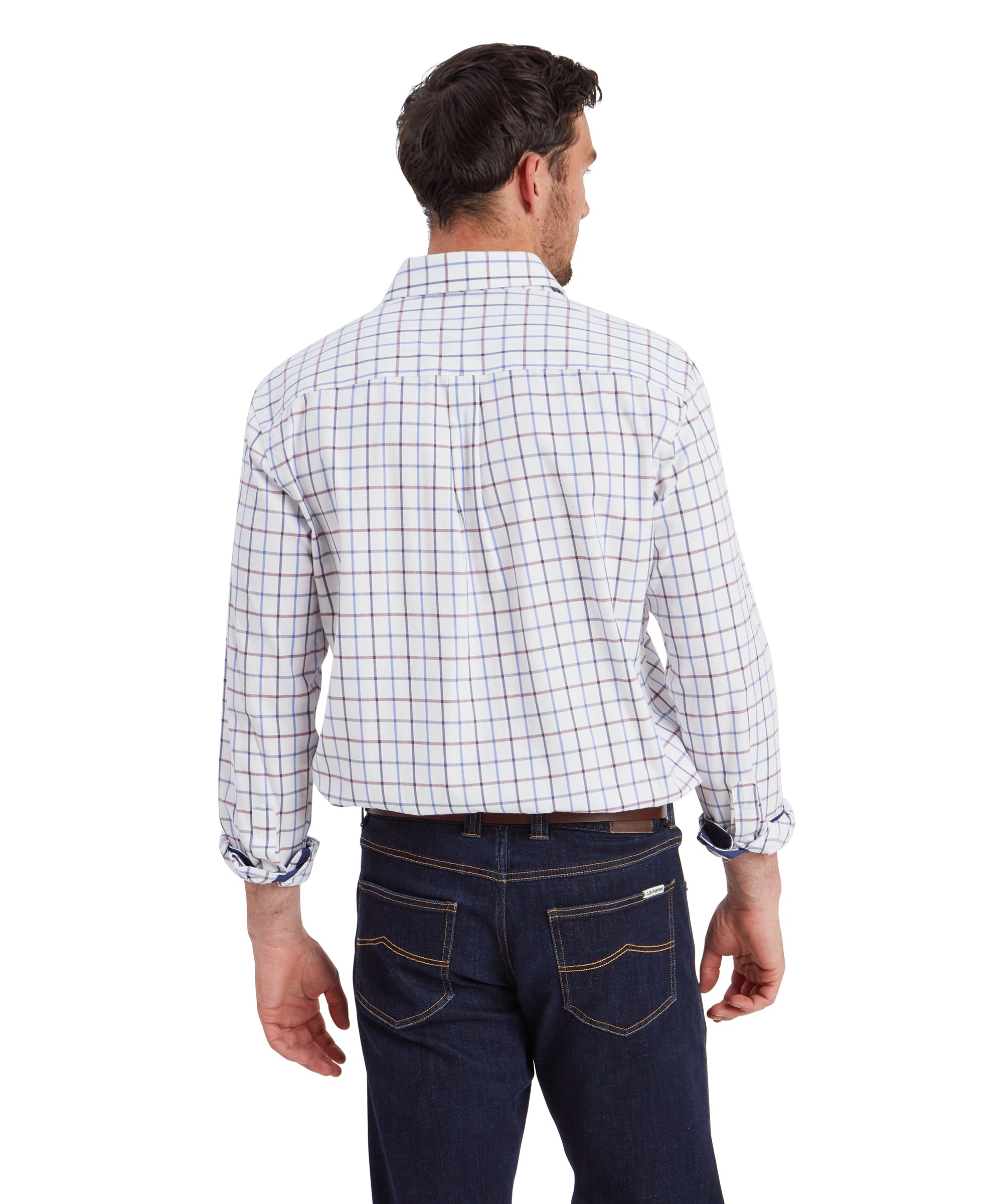 The man is standing with his back facing the camera, showcasing the rear details of his Schöffel Baconsthorpe Tailored Shirt for Men in Navy and Yellow and jeans. The shirt fits comfortably and is slightly loose around the back. The jeans have visible stitching on the back pockets, and his brown leather belt is prominently displayed.