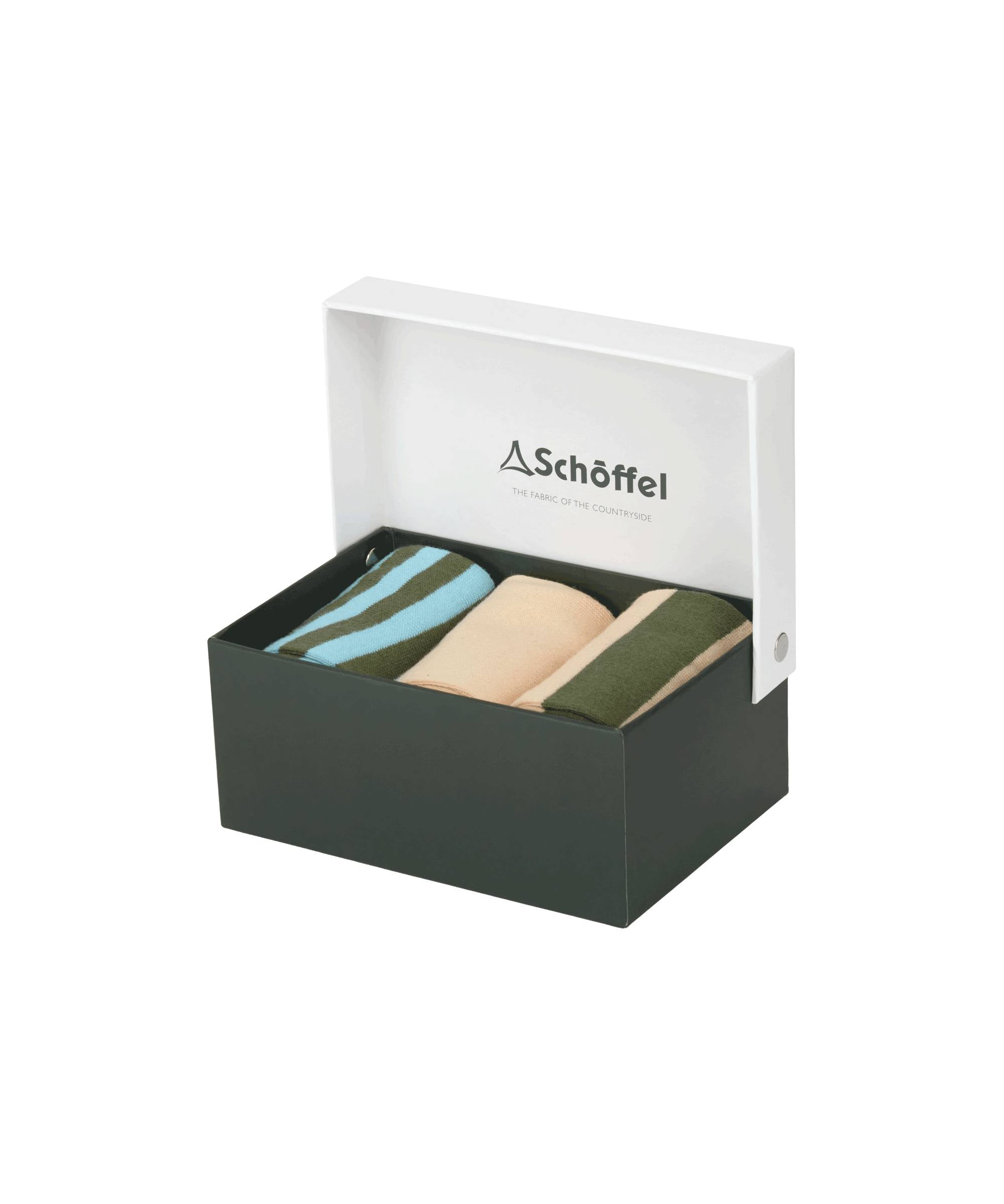 A dark green box with a white lid partially open, displaying the Schöffel Bamboo Sock Box of 3 for Men in Green inside. The socks are in different colors: one pair with blue and green stripes, another in solid beige, and the third in solid green. The inside of the lid features the "Schöffel" logo and the tagline "The Fabric of the Countryside."