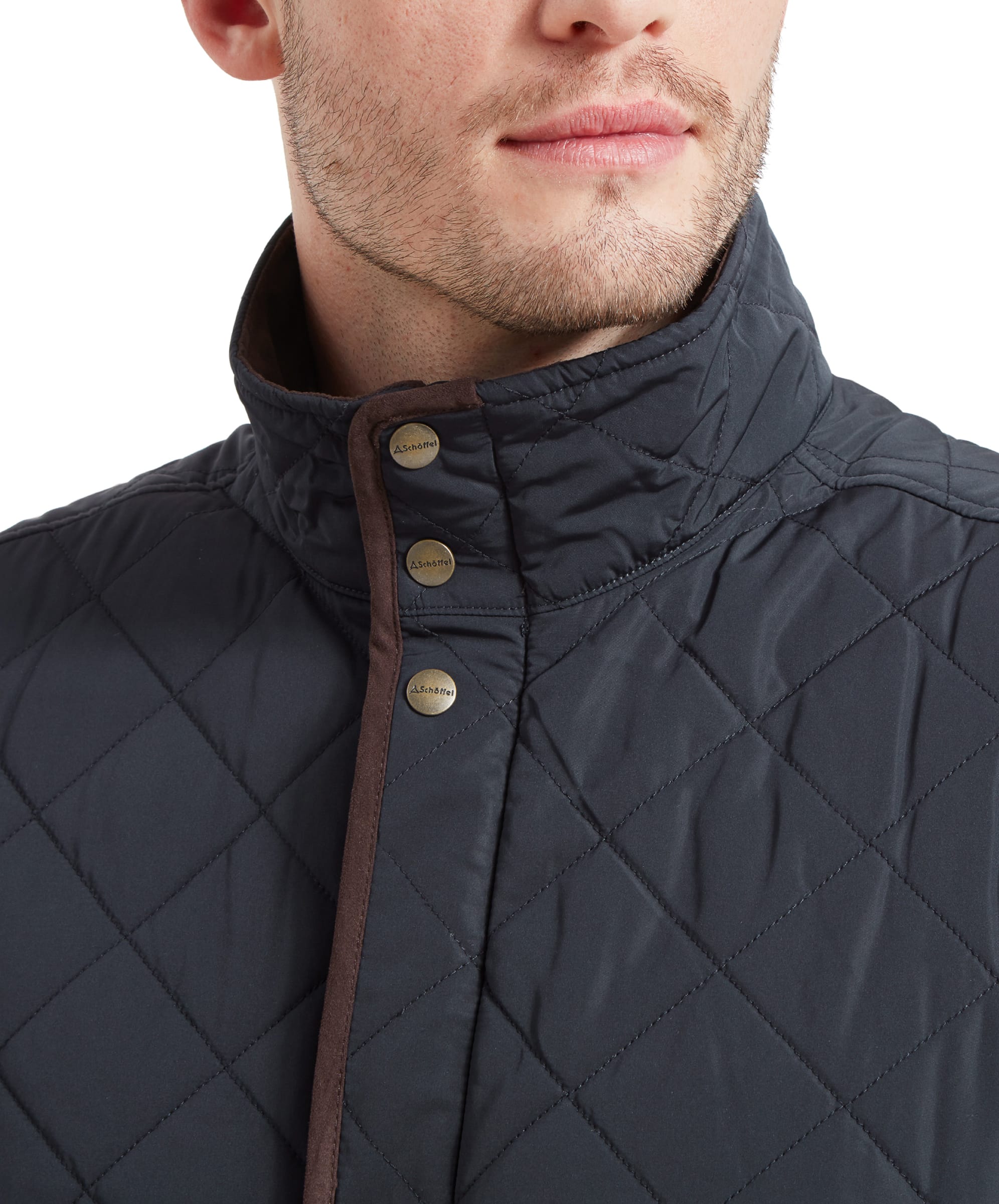 A close-up shot of a man wearing a Schöffel Barrowden Quilt Gilet for Men in Blue with brown trim, focusing on the collar and buttons with the "Schöffel" logo.