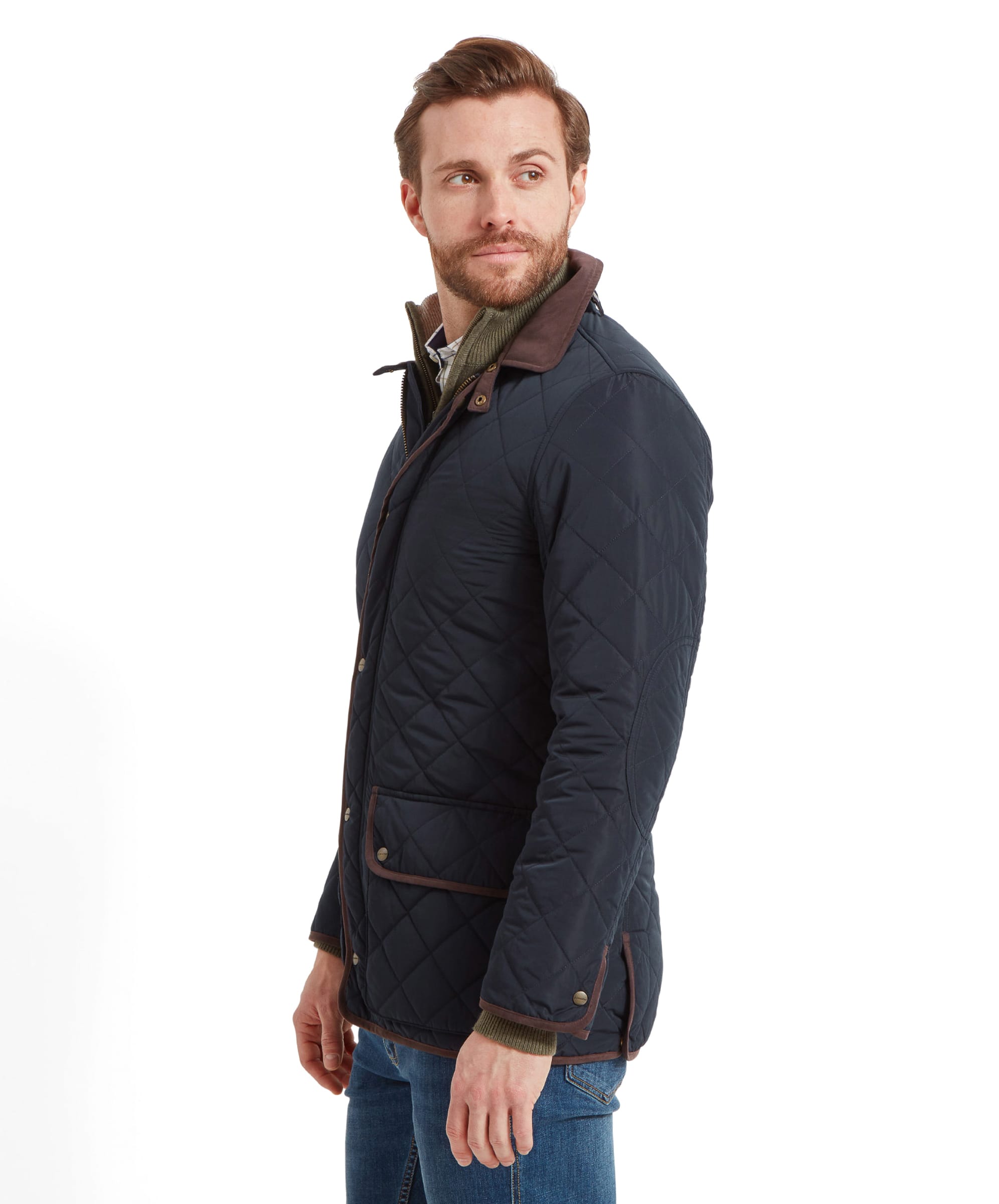 Side profile of the man wearing the Schöffel Barrowden Quilt Jacket for Men in Blue, looking over his shoulder with a neutral expression.