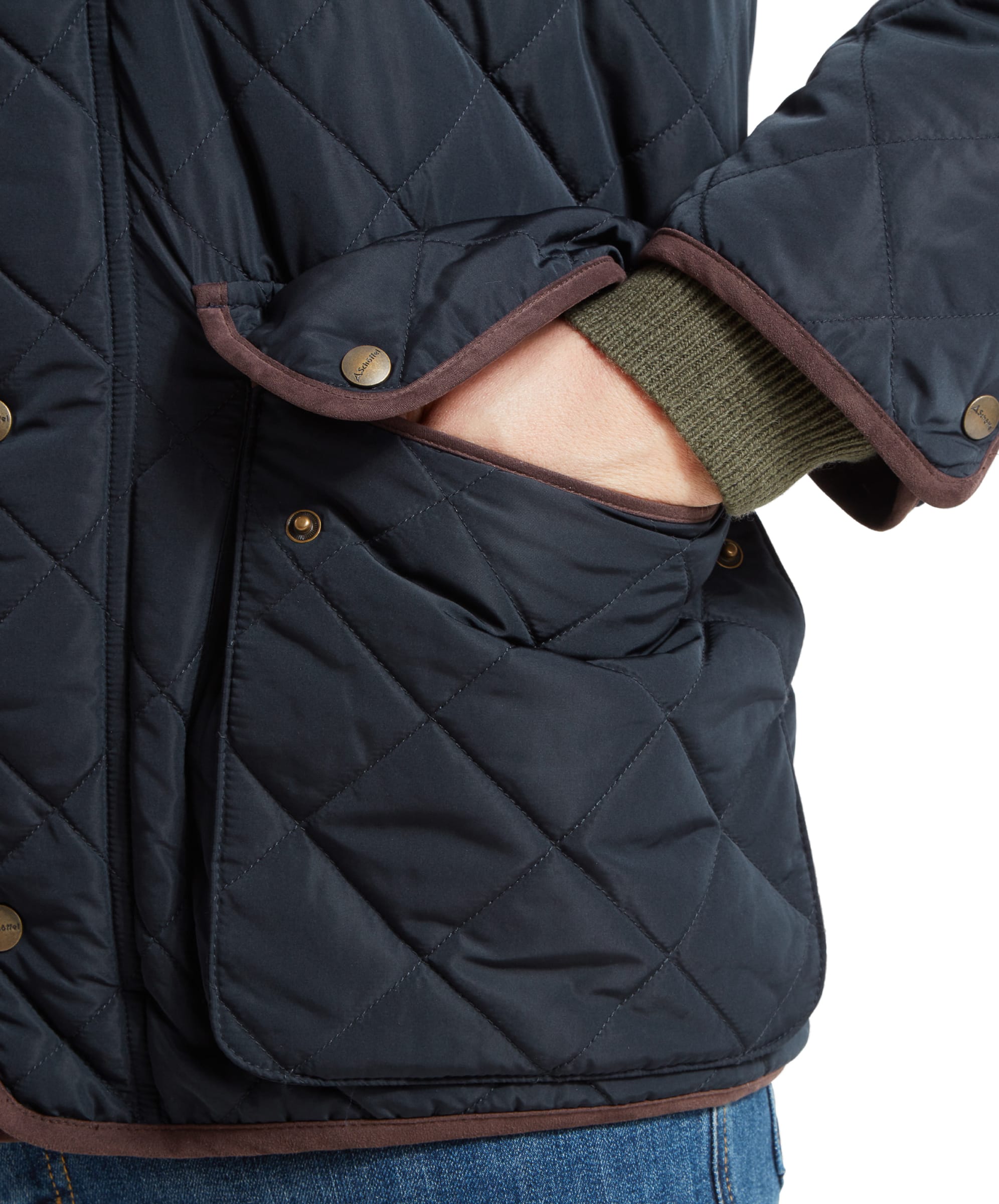 Close-up of the man's hand in the pocket of the Schöffel Barrowden Quilt Jacket for Men in Blue, highlighting the quilted texture and button detail.