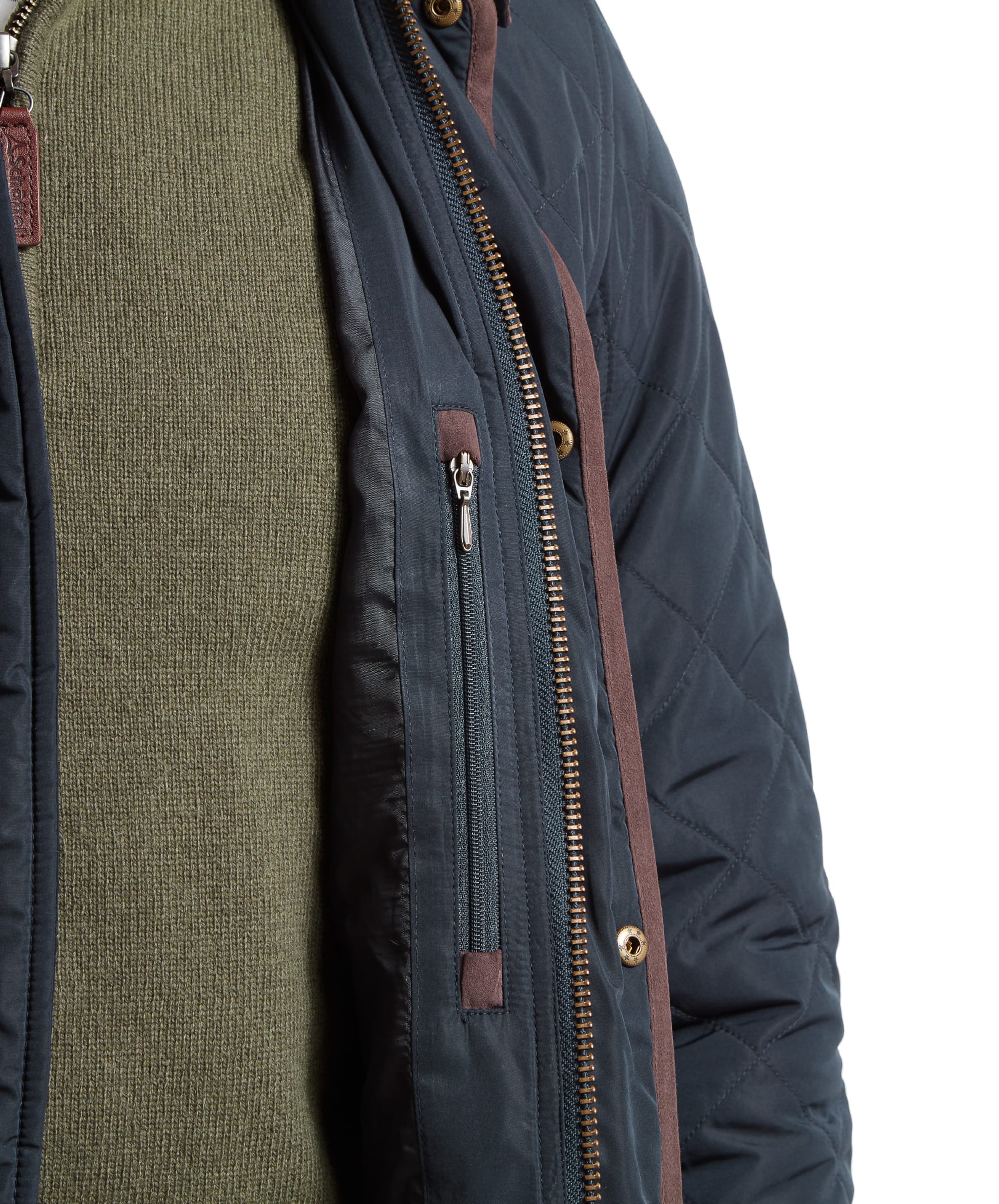 Close-up of the Schöffel Barrowden Quilt Jacket for Men in Blue's interior zipper pocket, showcasing the secure storage feature.