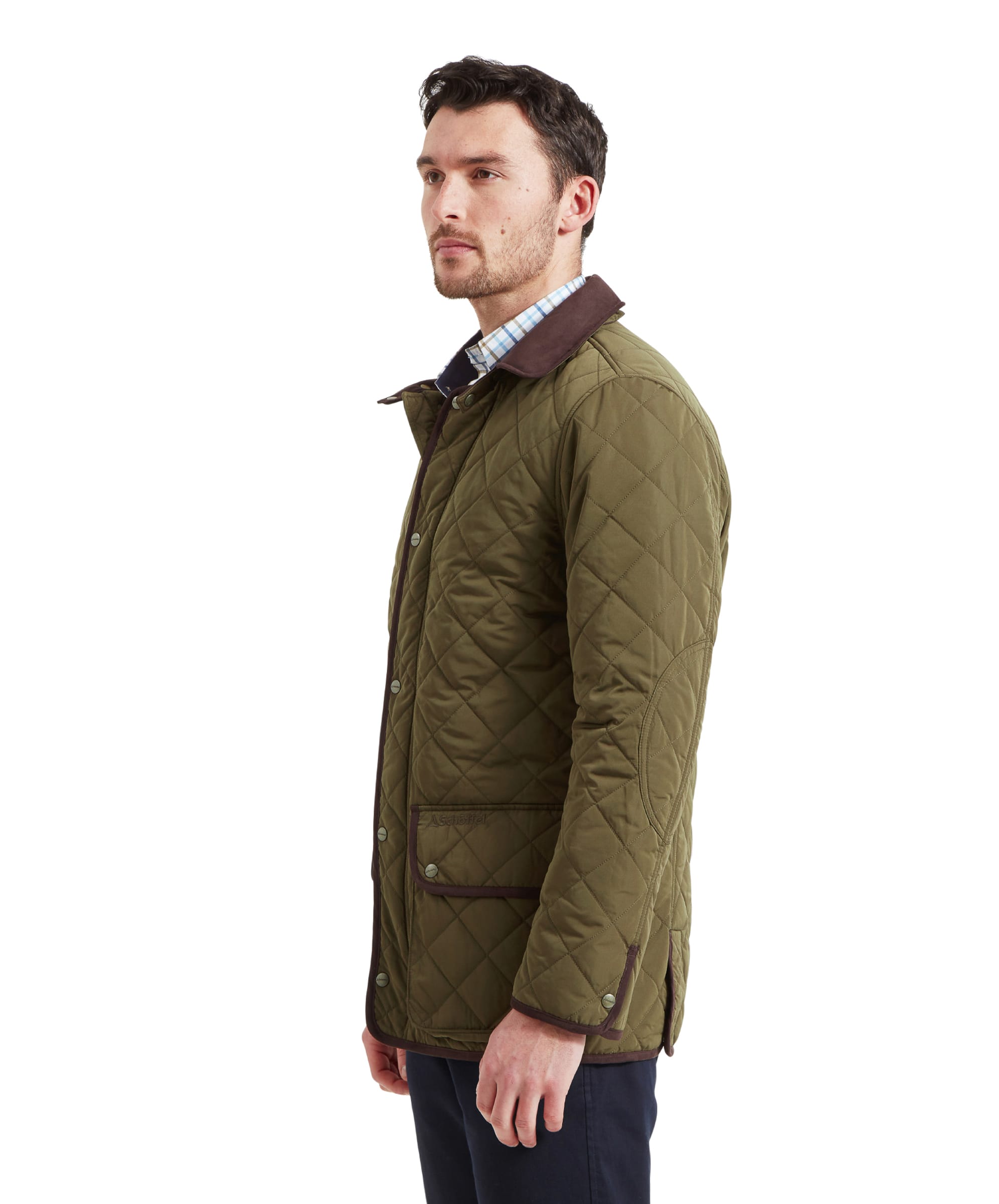 The man wearing the Schöffel Barrowden Quilt Jacket for Men in Green, turned to the side, showing the profile of the jacket.