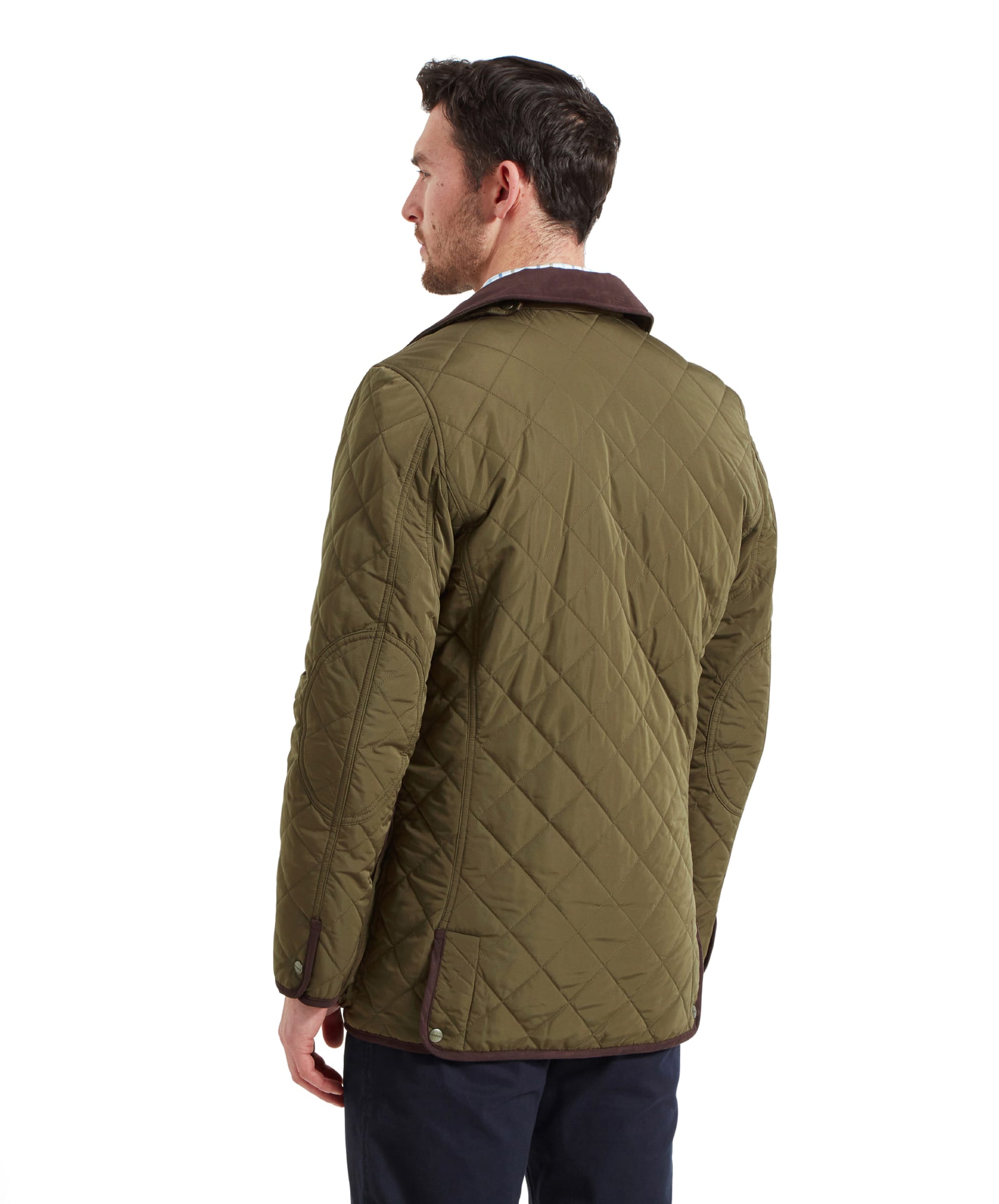 Back view of the man wearing the Schöffel Barrowden Quilt Jacket for Men in Green, highlighting the quilted pattern and back design.