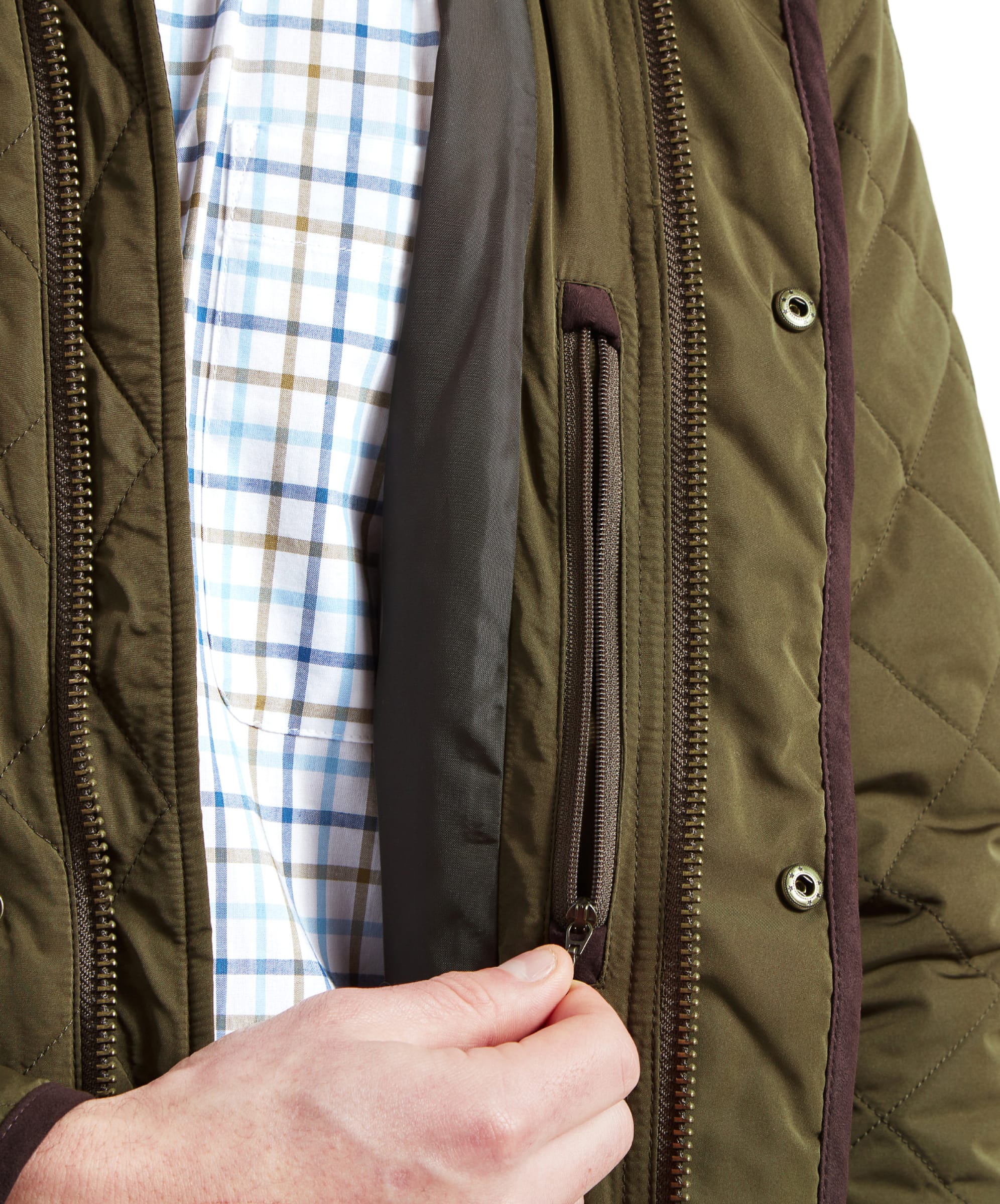 Inside view of the Schöffel Barrowden Quilt Jacket for Men in Green, showing the zippered security pocket and plaid shirt underneath.