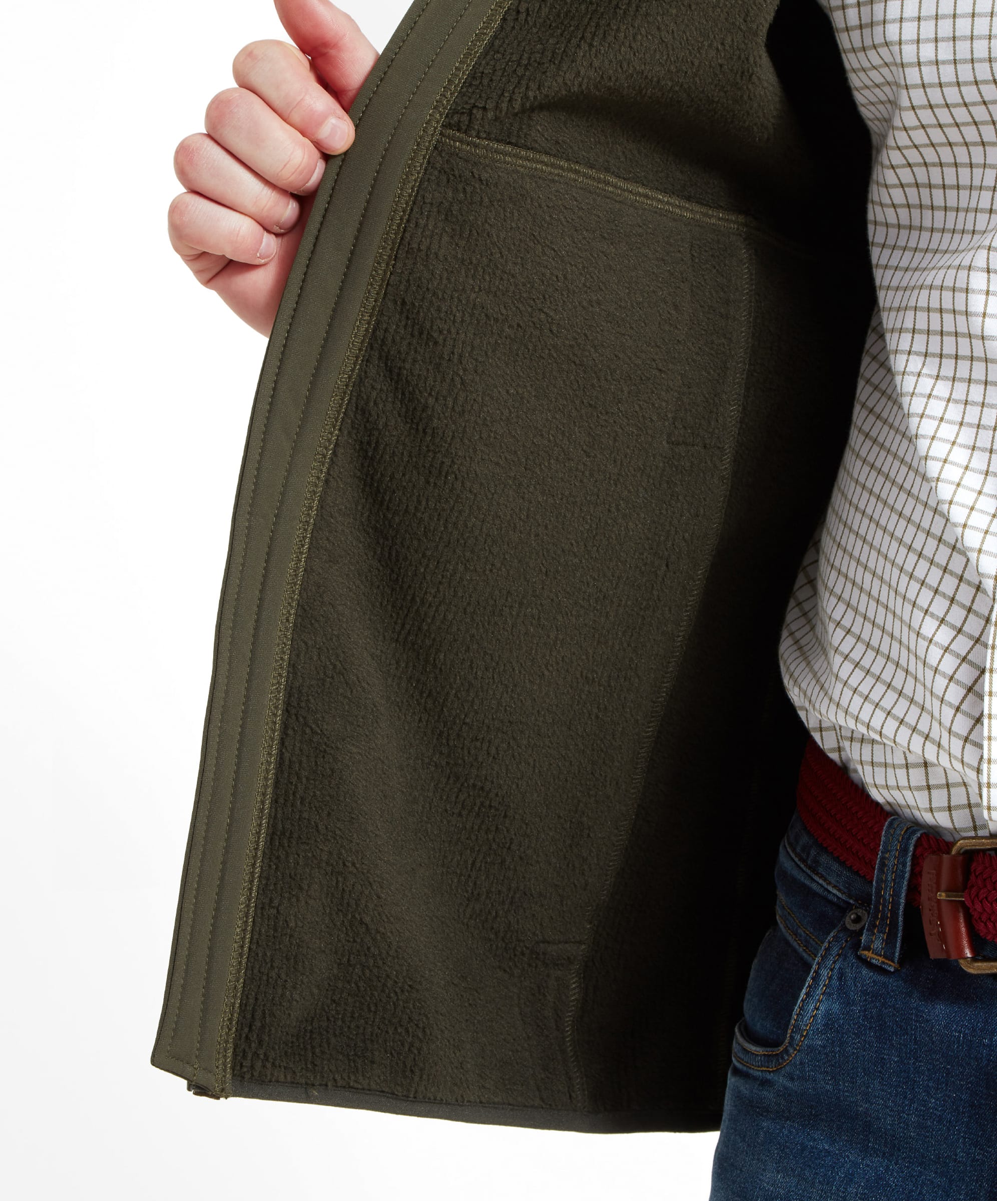 A close-up of the inner pocket of the Schöffel Belton Gilet for Men in Green, with the man's hand partially visible.