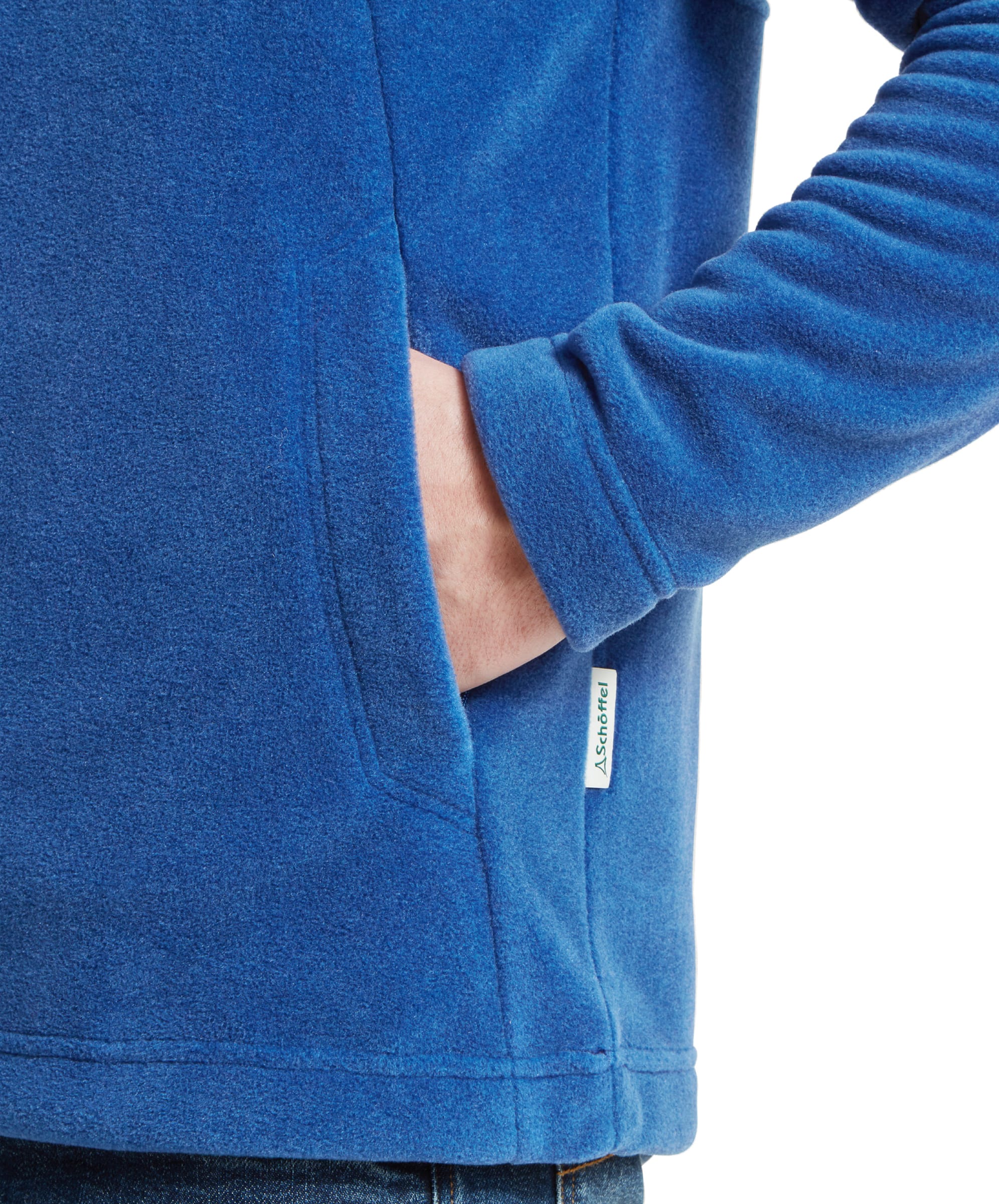 A close-up of the man's right hand in the pocket of the Schöffel Berkeley Fleece 1/4 Zip Fleece for Men in Blue, highlighting the texture and the Schöffel brand label.