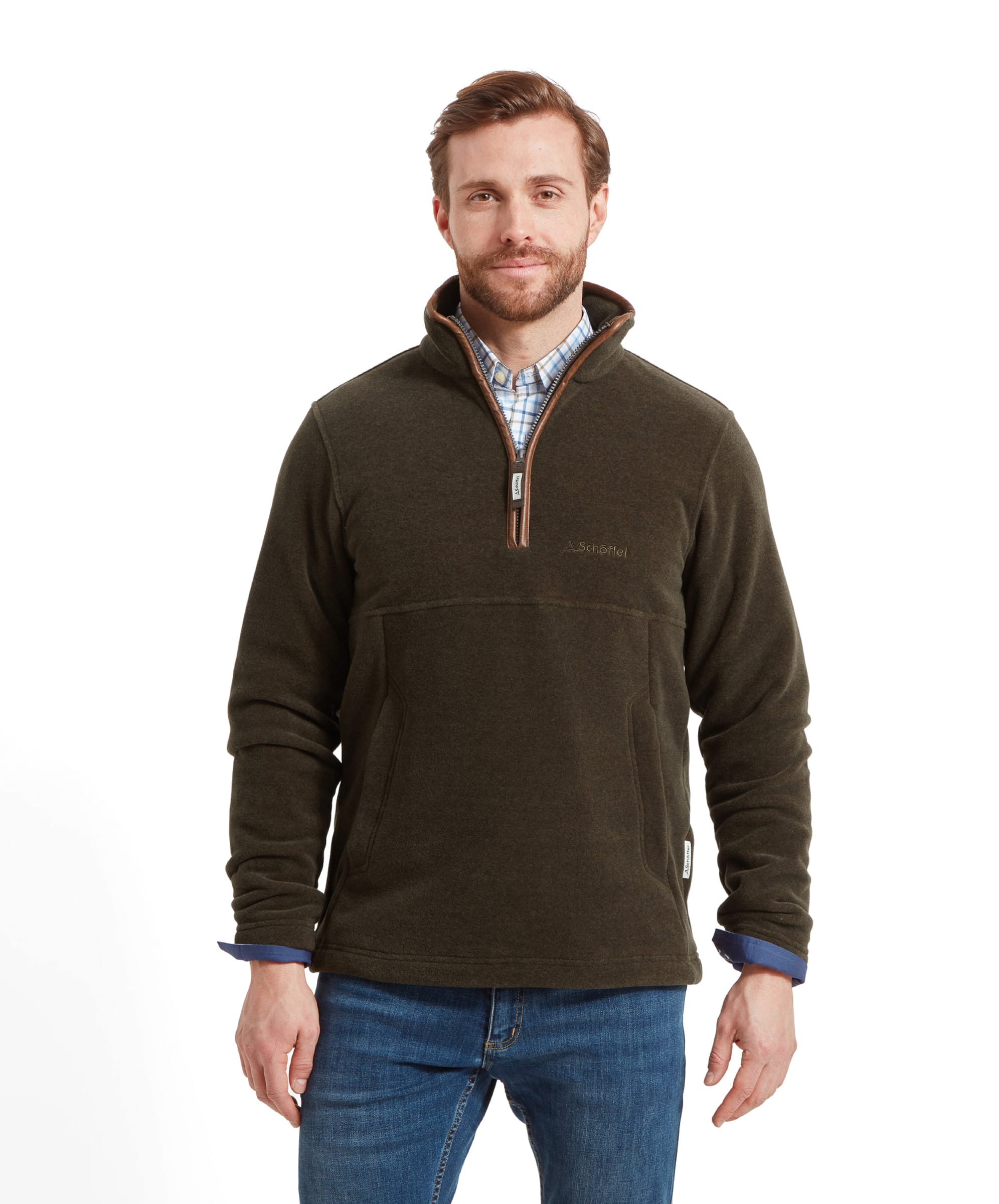 Man wearing a Schöffel Berkeley Fleece 1/4 Zip Fleece for Men in Olive Green, partnered with light blue jeans and a checked shirt, standing with hands by sides.