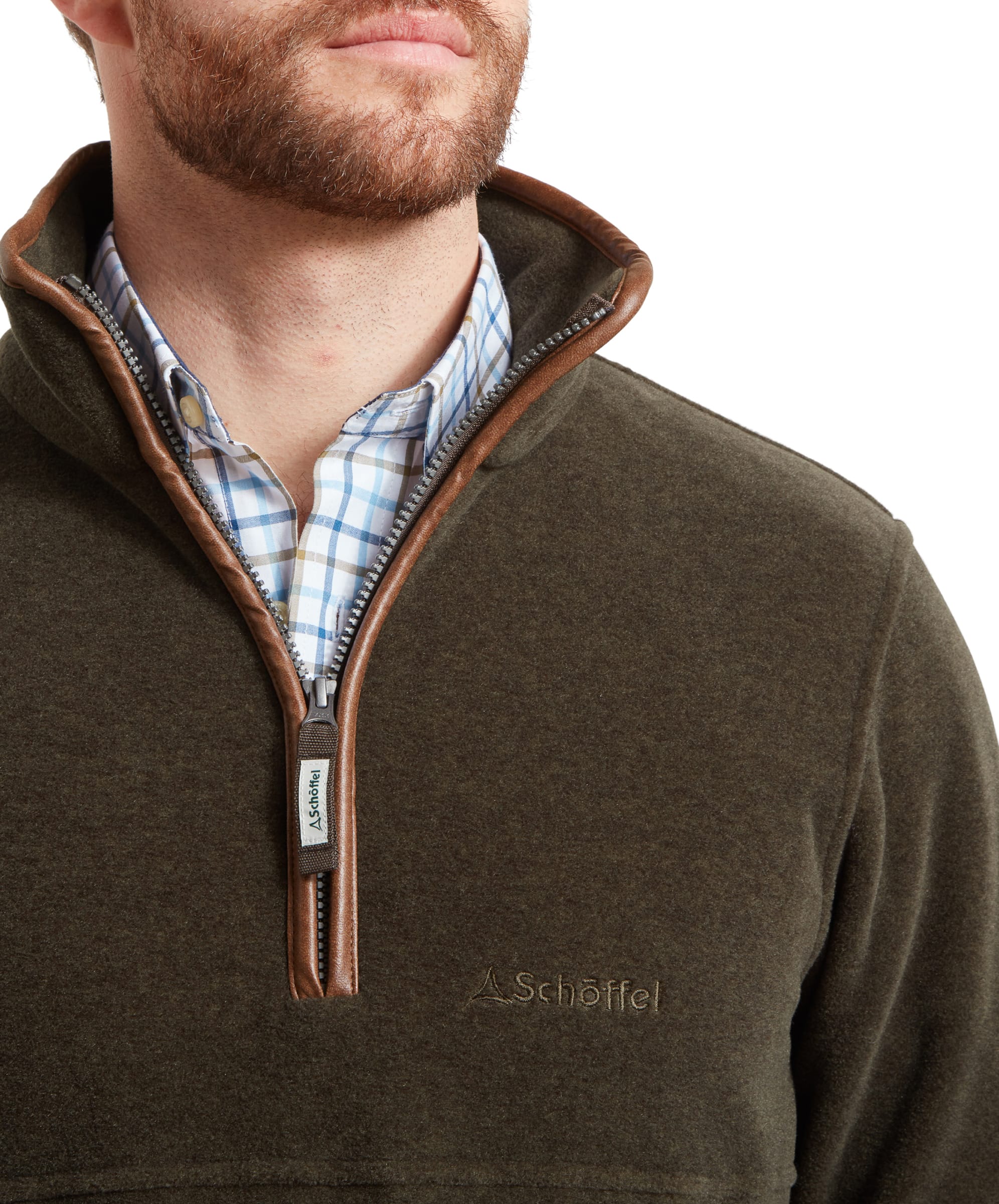 Close-up of man's chest showing the logo on the Schöffel Berkeley Fleece 1/4 Zip Fleece for Men in Olive Green.