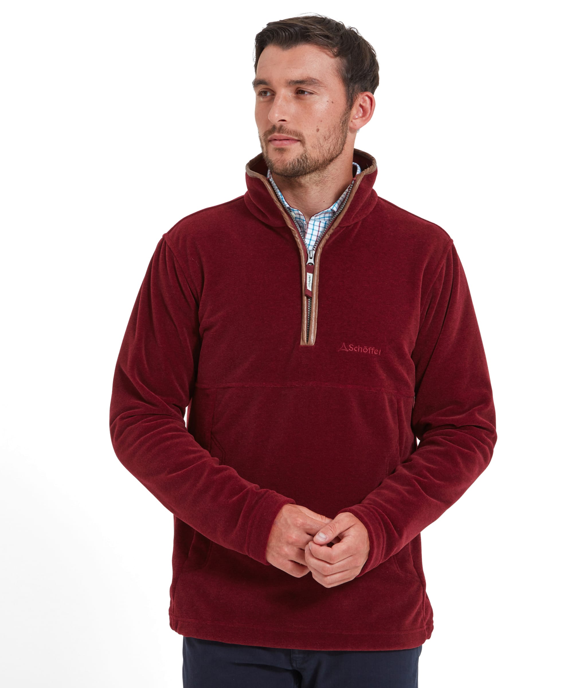 A man wearing a Schöffel Berkeley Fleece 1/4 Zip Fleece for Men in Red and standing with his hands clasped.