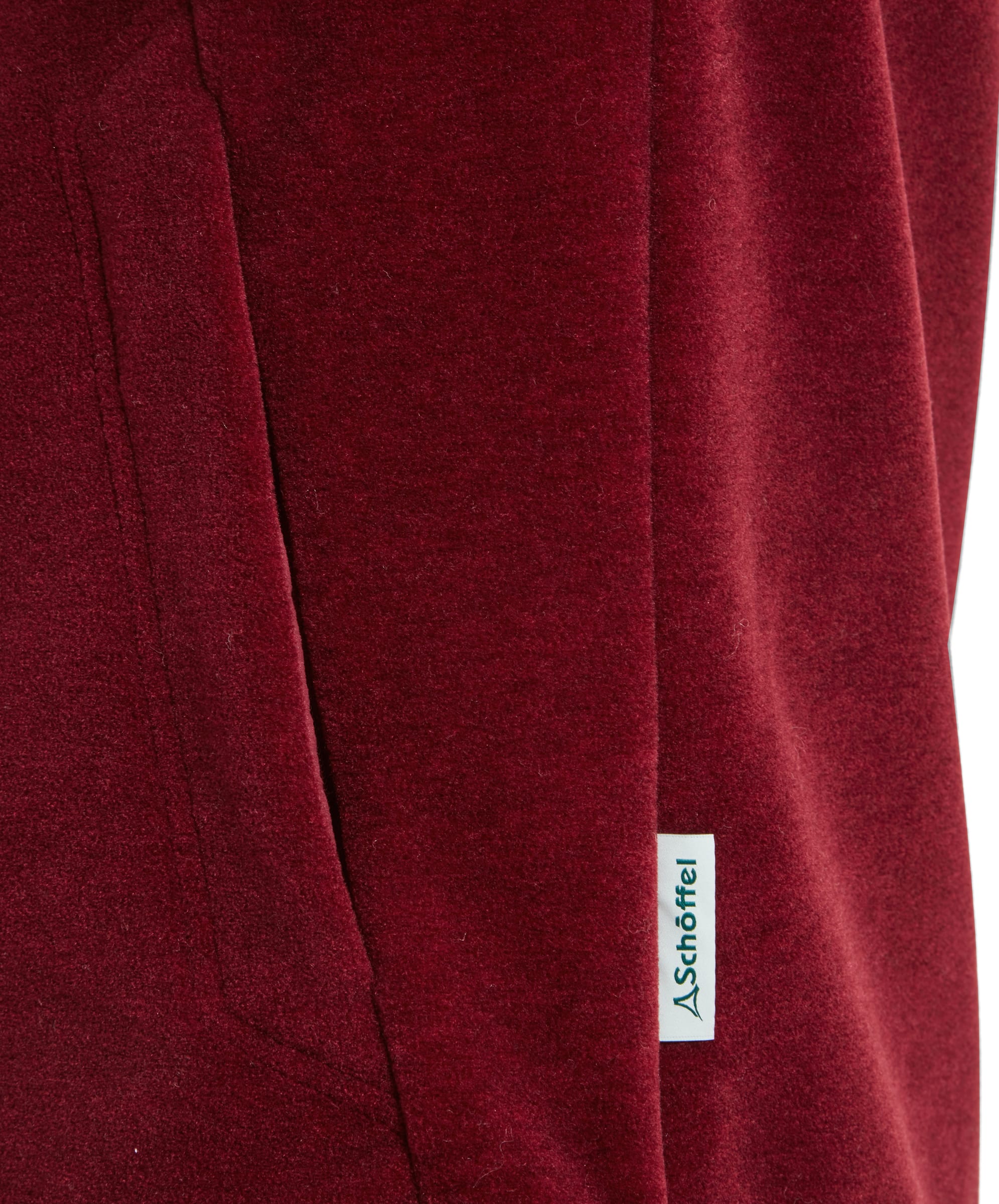 Close-up of the side pocket of the Schöffel Berkeley Fleece 1/4 Zip Fleece for Men in Red, highlighting the Schöffel logo tag.