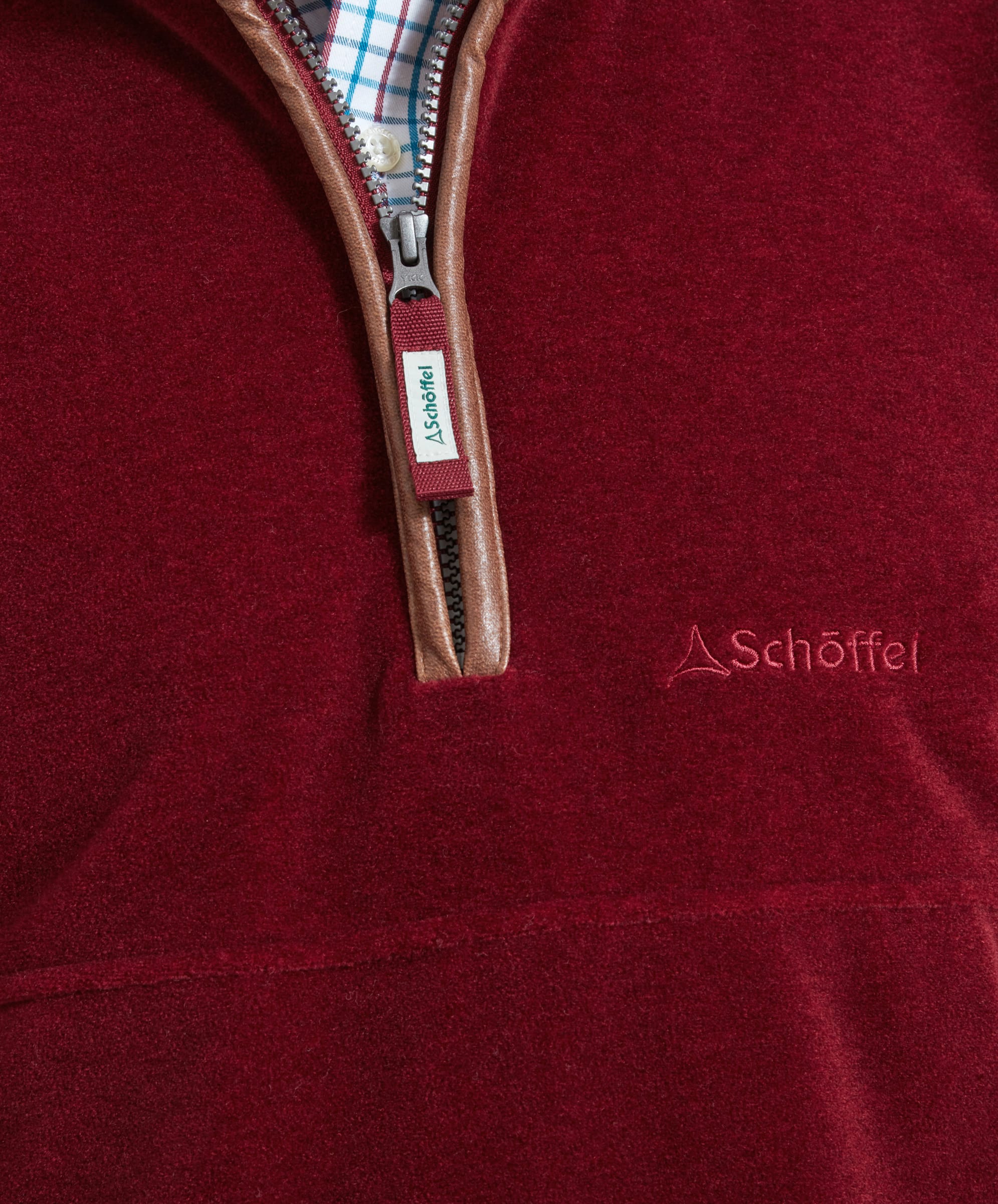 Close-up of the Schöffel Berkeley Fleece 1/4 Zip Fleece for Men in Red and the Schöffel logo on the chest.