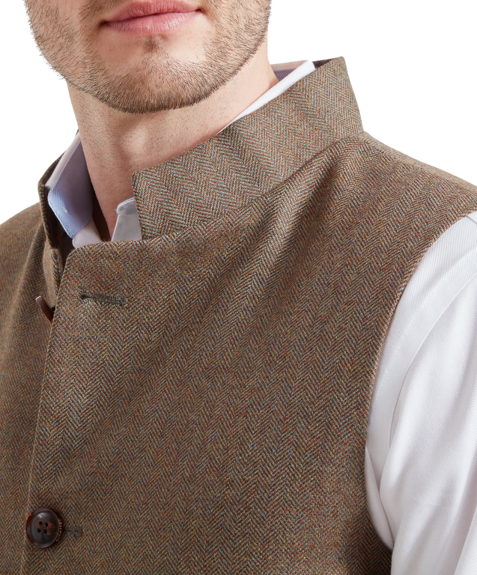 A close-up of the Schöffel Berwick Nehru Tweed Waistcoat for Men in Green's lapel and collar, showcasing the herringbone pattern and brown buttons.