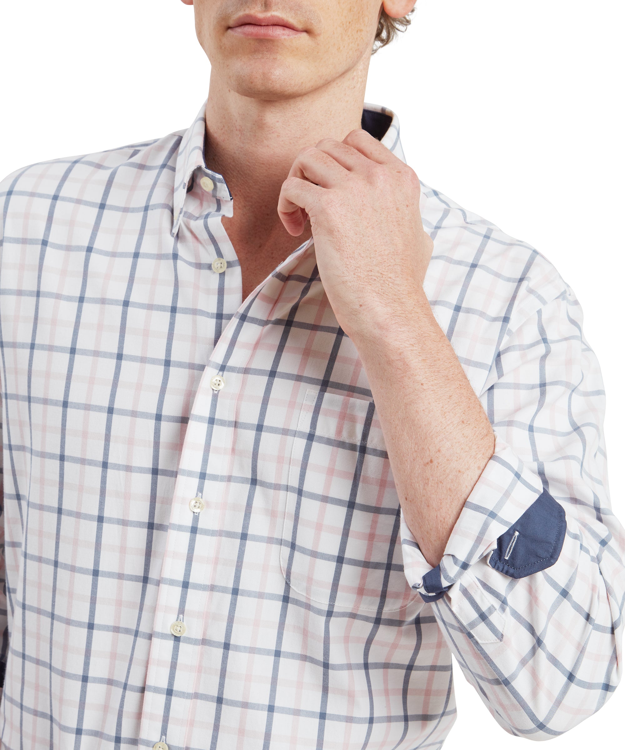 A close-up shot of the man adjusting his Schöffel Brancaster Classic Shirt for Men in Blue's collar with his right hand. The focus is on the shirt's checkered pattern, the collar's crispness, and the man's casual yet polished style. The inner cuff detail, which contrasts with the outer fabric, is also visible as he holds the collar.