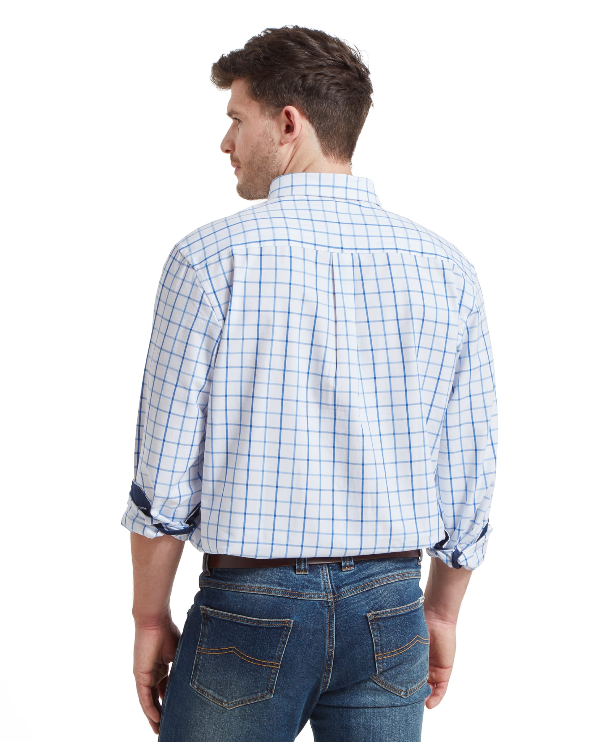 A back view of the man in the Schöffel Brancaster Classic Shirt for Men in Blue and jeans, showing the rear design of the shirt. His head is turned slightly to the right.