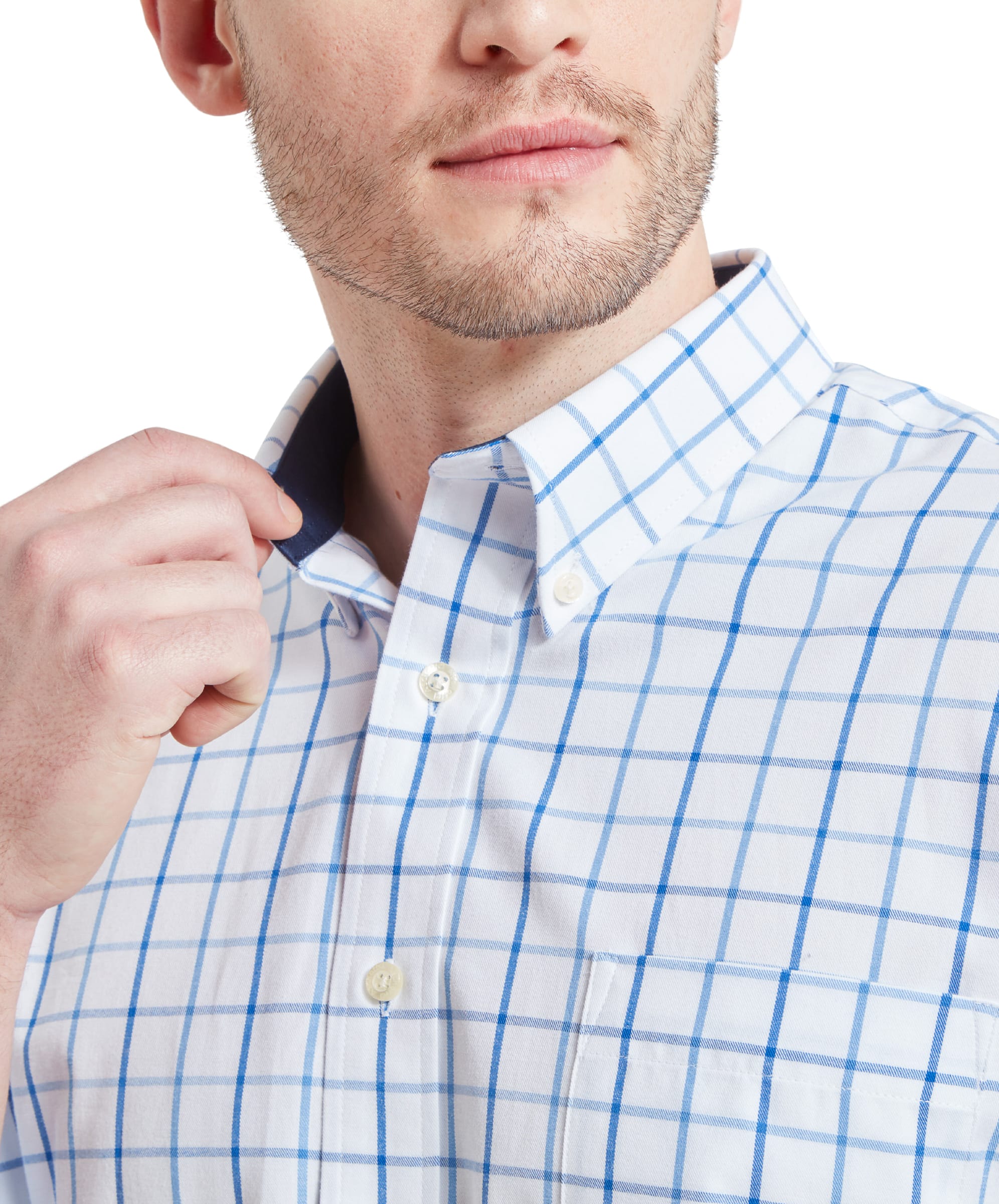 A close-up of the man's hand adjusting the collar of the Schöffel Brancaster Classic Shirt for Men in Blue, highlighting the collar details and buttons.