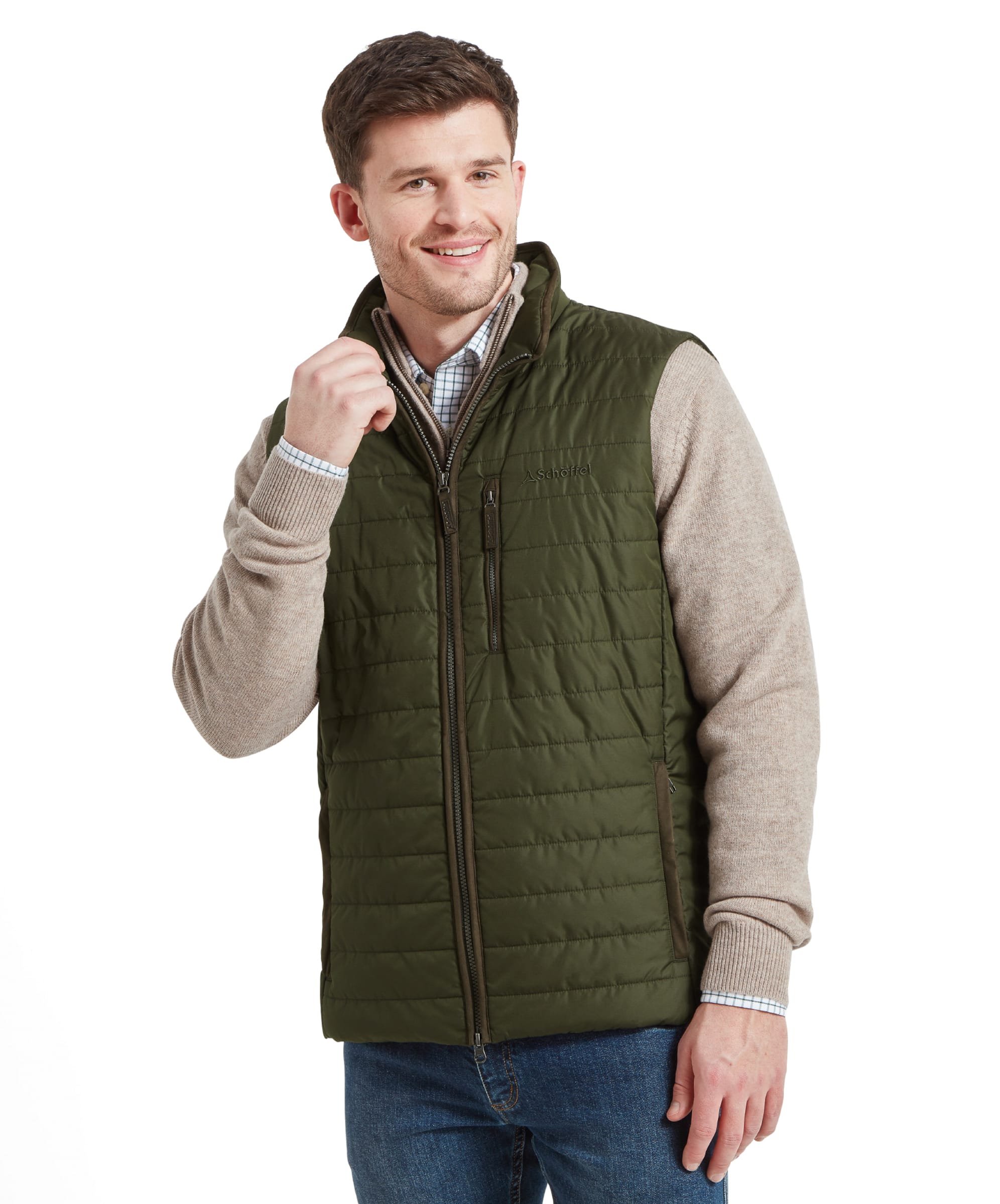 A model in a Schöffel Brora Gilet for Men in Green with a full zipper and high collar, smiling and holding the zipper with one hand.