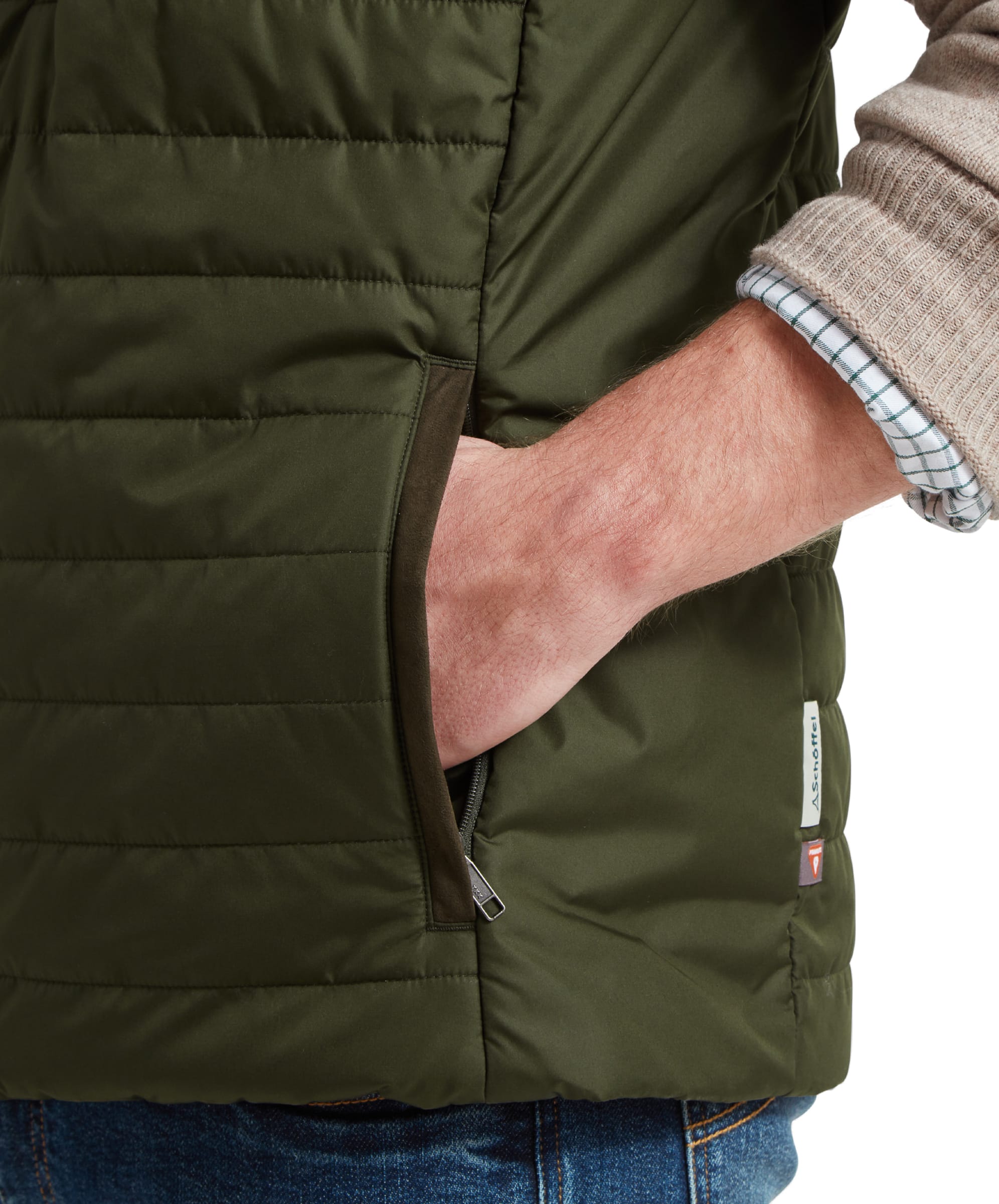 Close-up of the Schöffel Brora Gilet for Men in Green's pocket with the model's hand inside, highlighting the gilet's fabric and texture.