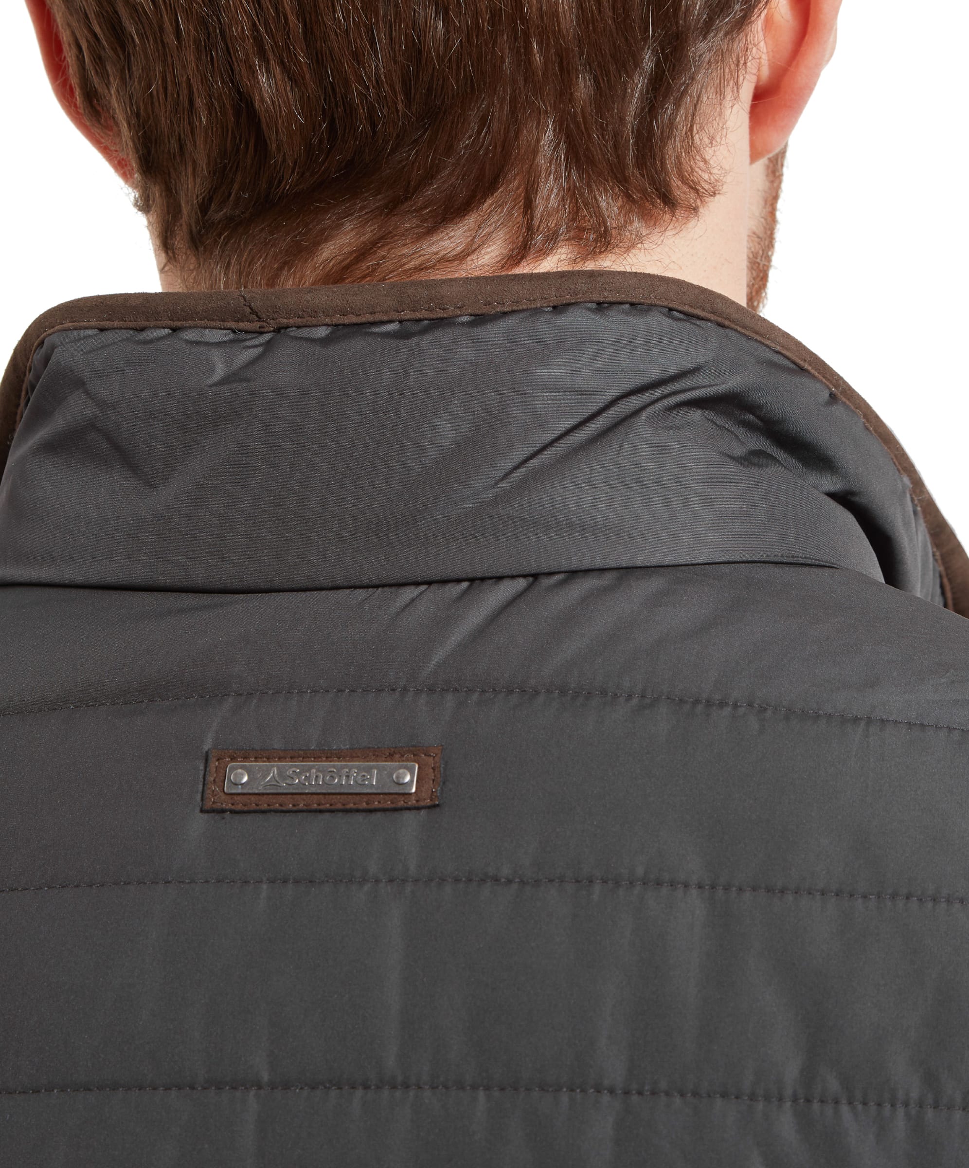 A close-up shot of the back collar area, showing the Schöffel Brora Gilet for Men in Grey with a branded Schöffel leather patch and the high collar design for added warmth.