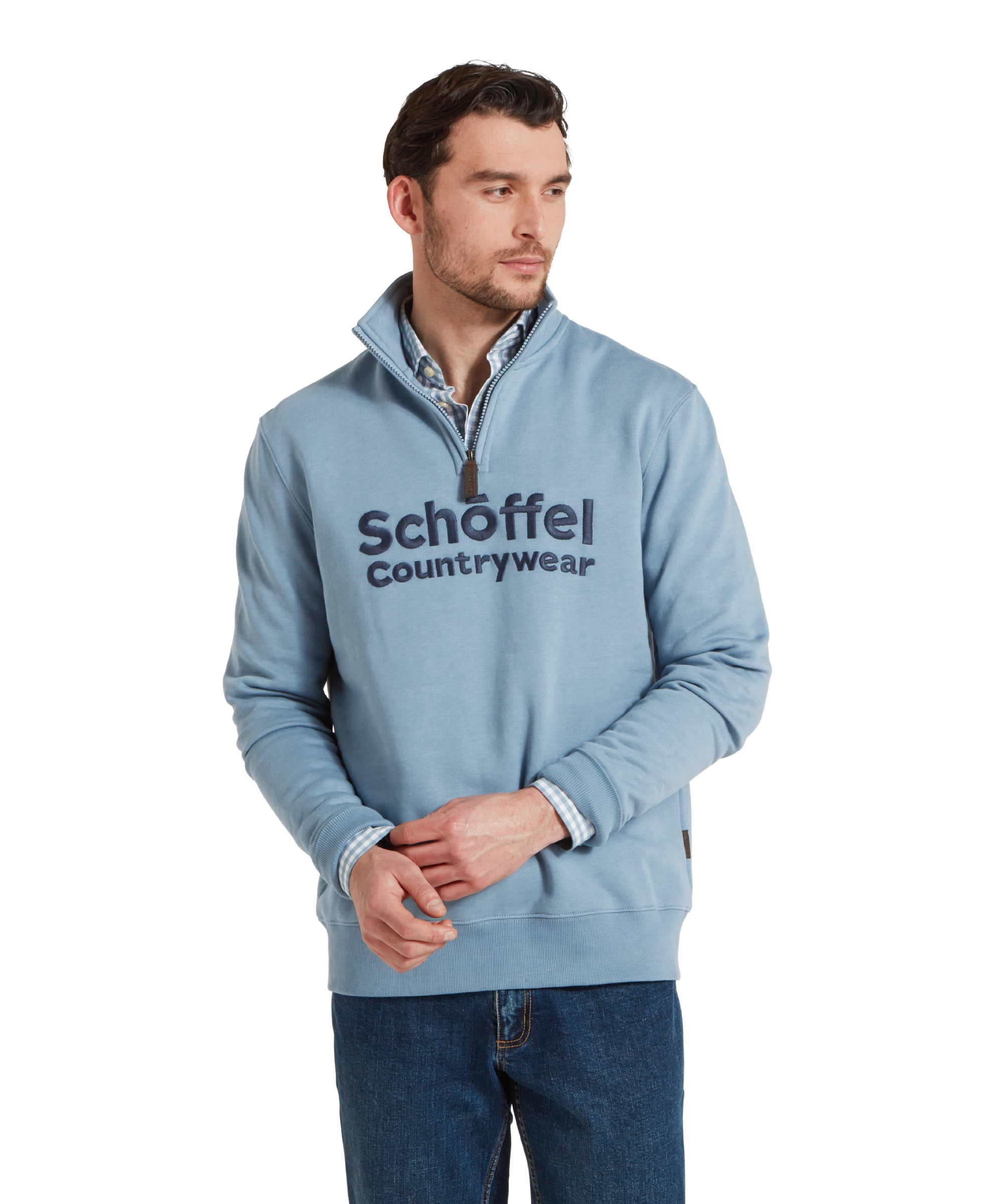 Half height image of a man wearing the Schöffel Bude Sweatshirt for Men in Blue, standing in a relaxed pose, looking slightly to the side.