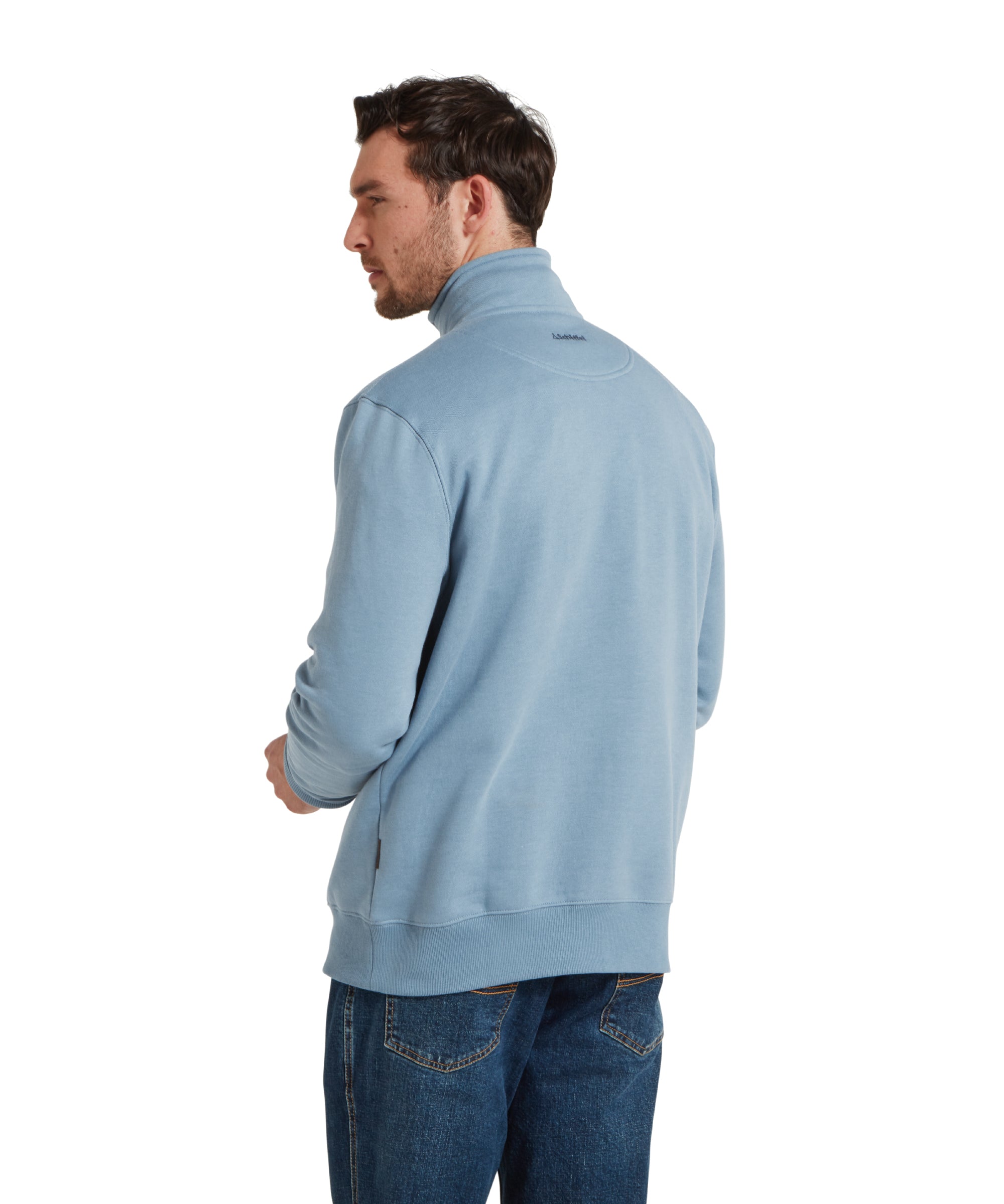 Back image of a man wearing the Schöffel Bude Sweatshirt for Men in Blue paired with dark blue jeans, navy trainers and checked shirt. He is standing in a relaxed pose, looking slightly to the side.