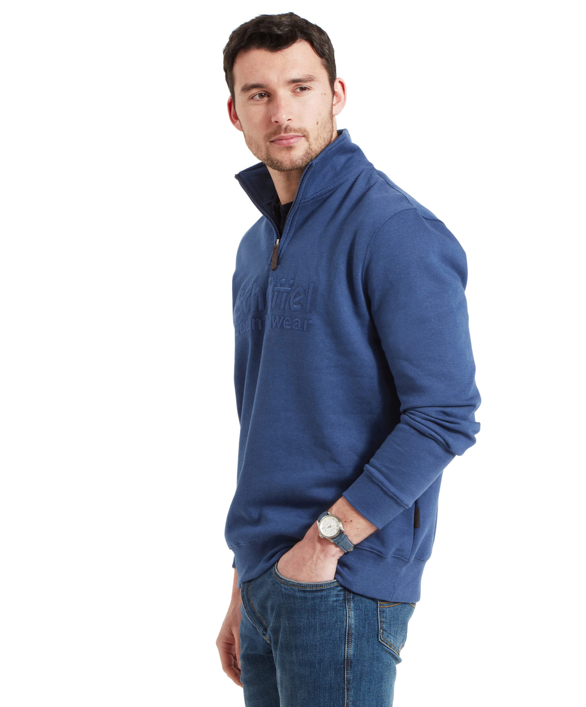 Side profile of the man in a Schöffel Bude Sweatshirt for Men in Blue, with his left hand in his pocket, looking over his right shoulder.