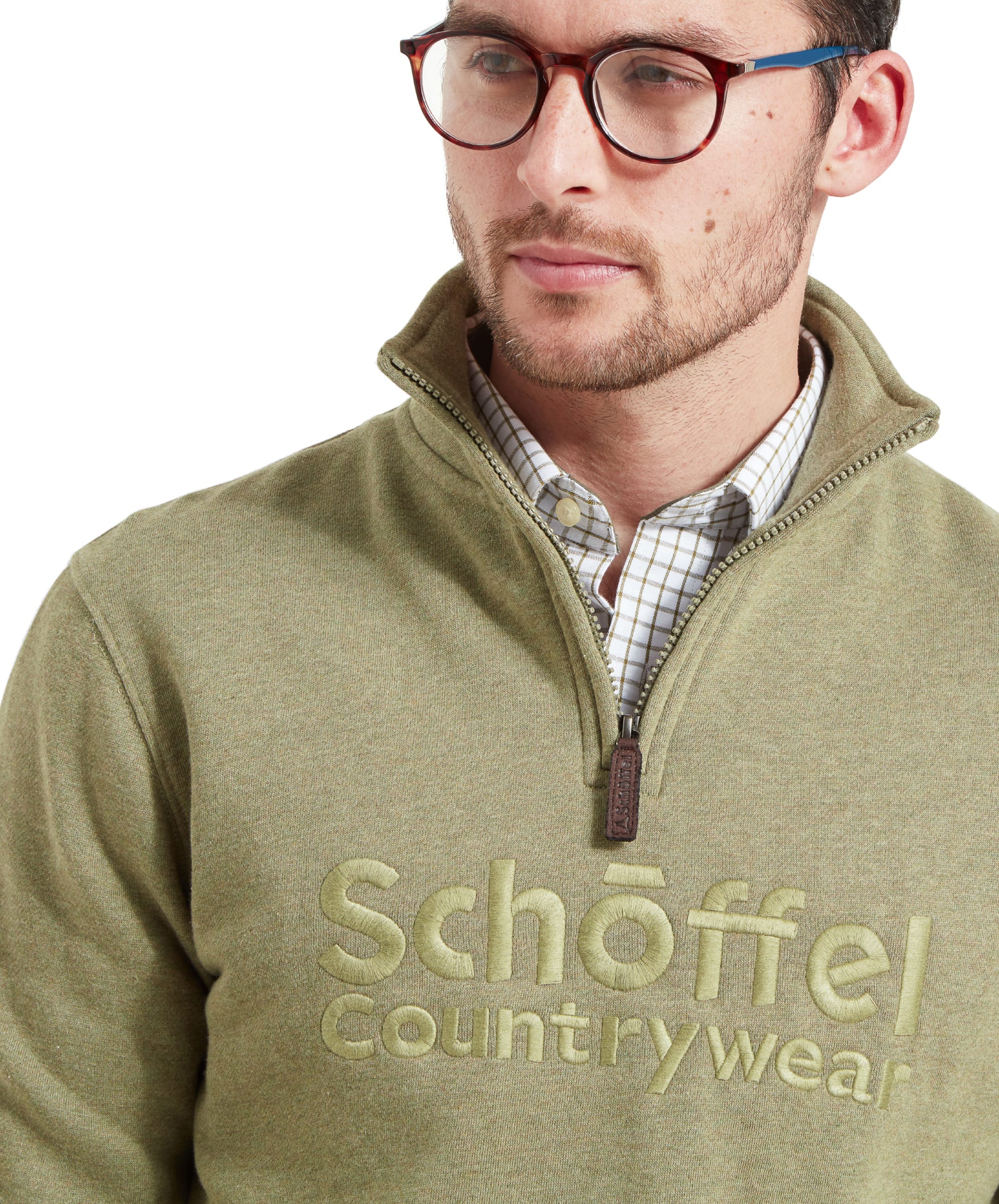 Close-up of the man's chest, highlighting the embroidered Schöffel Countrywear logo on the Schöffel Bude Sweatshirt for Men in Light Green.