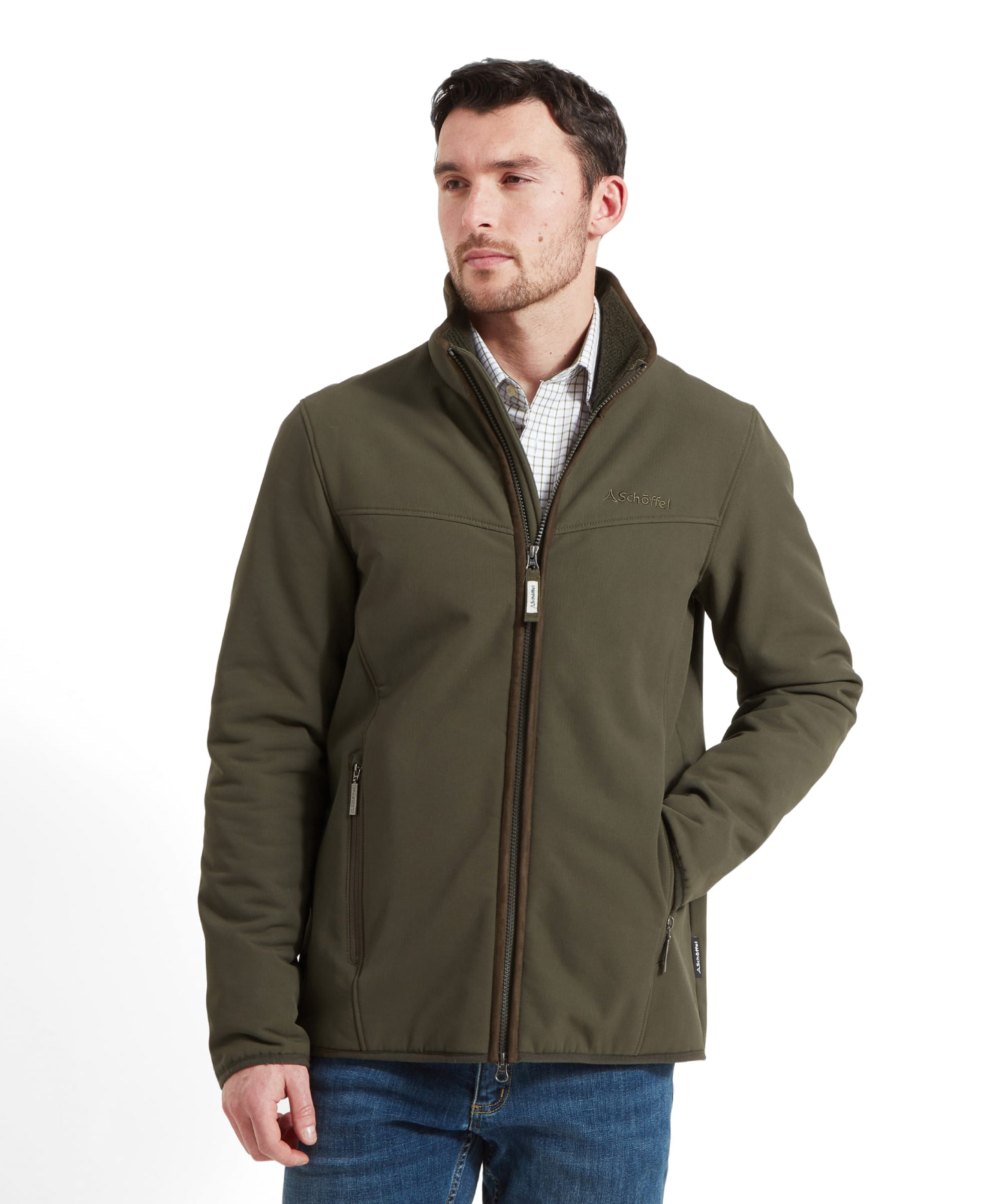 A man wearing the Schöffel Men's Burrough Jacket in Green, standing with his hands in his pockets.