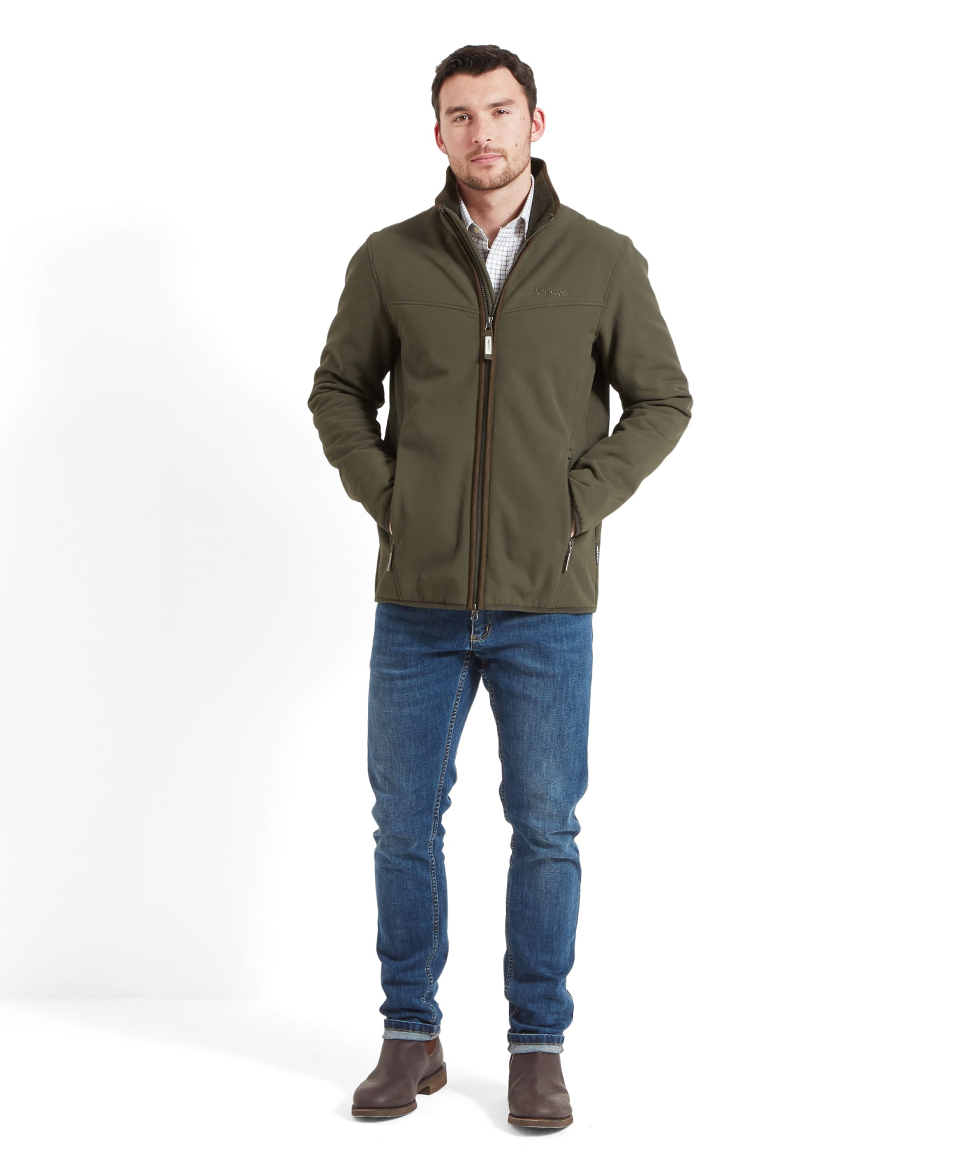 Full-body shot of a man wearing the Schöffel Men's Burrough Jacket in Green, paired with jeans and brown boots.