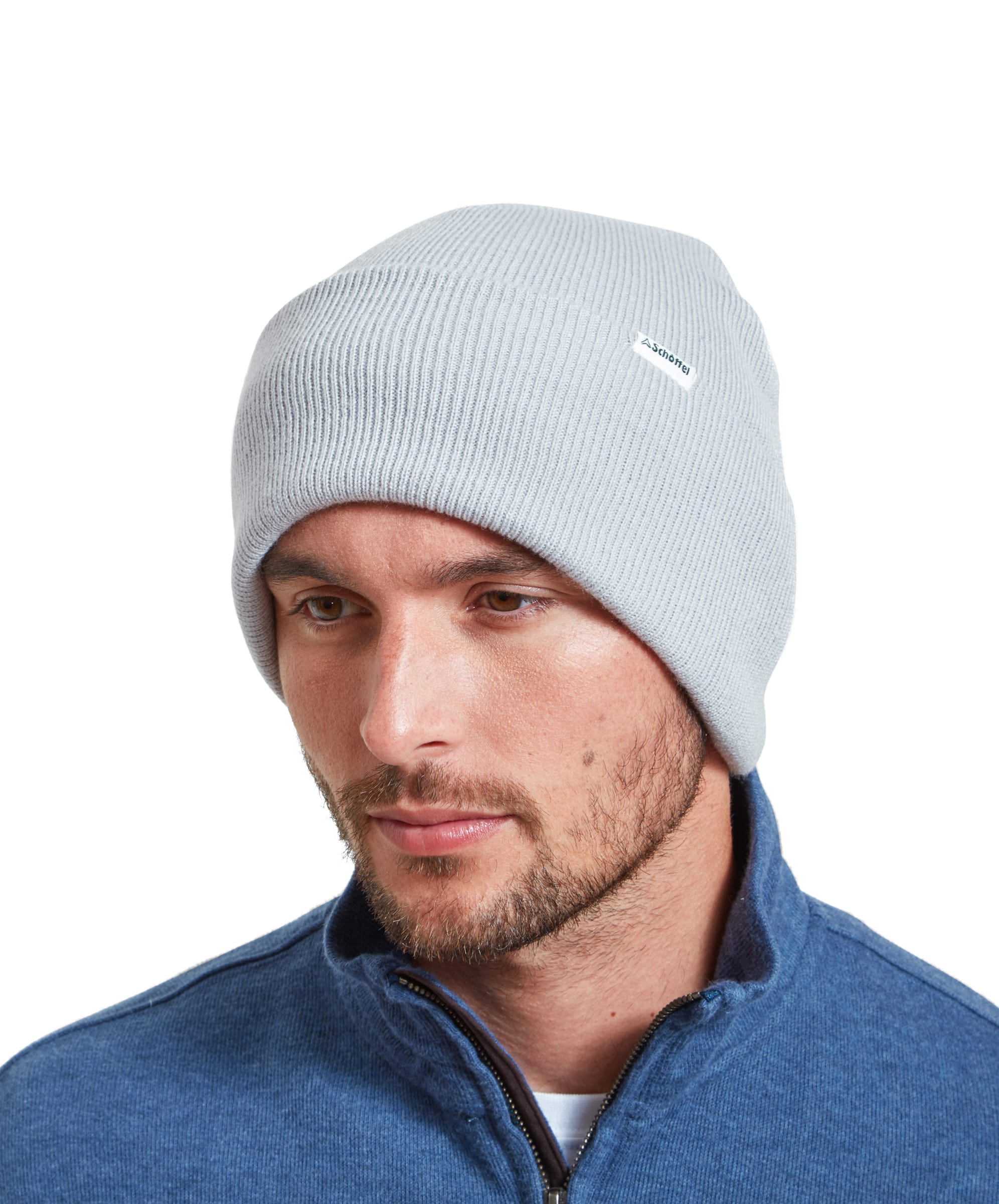 A model wears a Schöffel Buxton Beanie for Men in Grey whilst looking away from the camera and styled with a blue zip sweater.