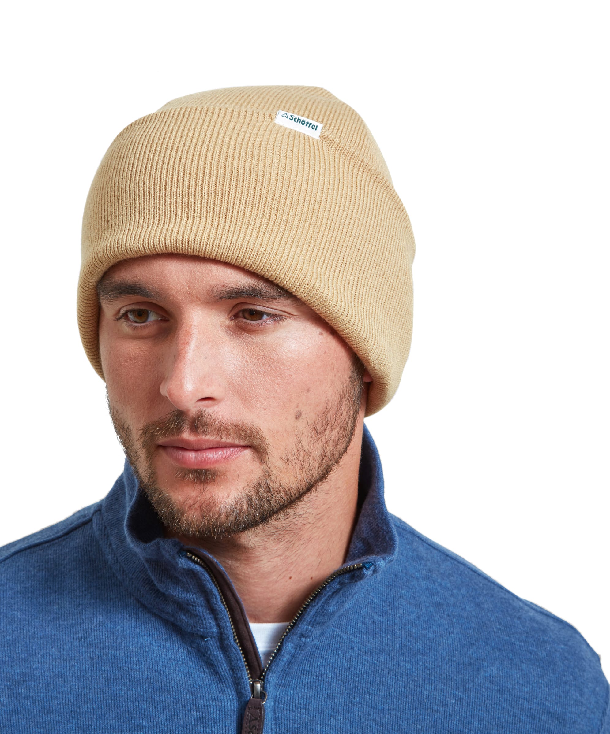 A model wears a Schöffel Buxton Beanie for Men in Light Brown whilst looking away from the camera and styled with a blue zip sweater.