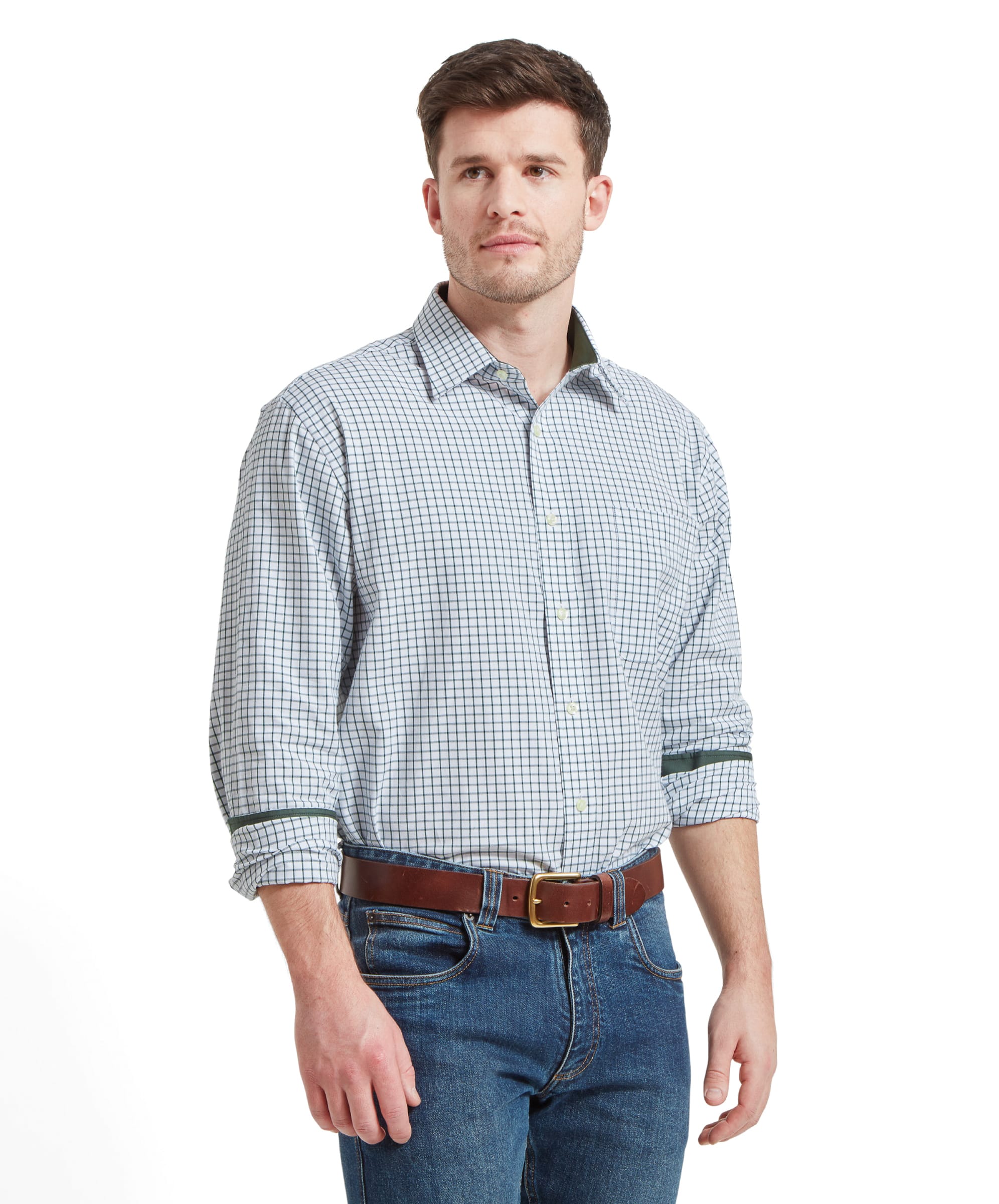 A man wearing a Schöffel Cambridge Classic Shirt for Men in Green, standing with a neutral expression and his left hand in his pocket.