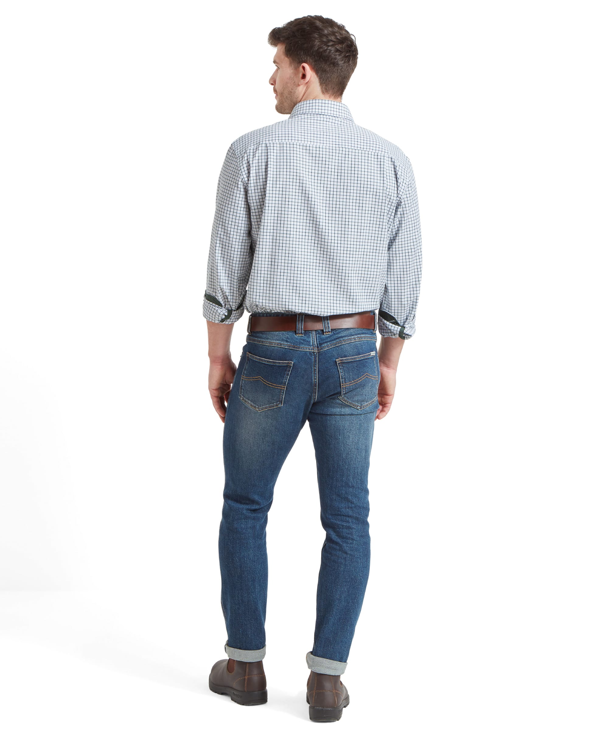 Full-body back view of the man in the Schöffel Cambridge Classic Shirt for Men in Green, displaying the fit of the shirt and jeans.