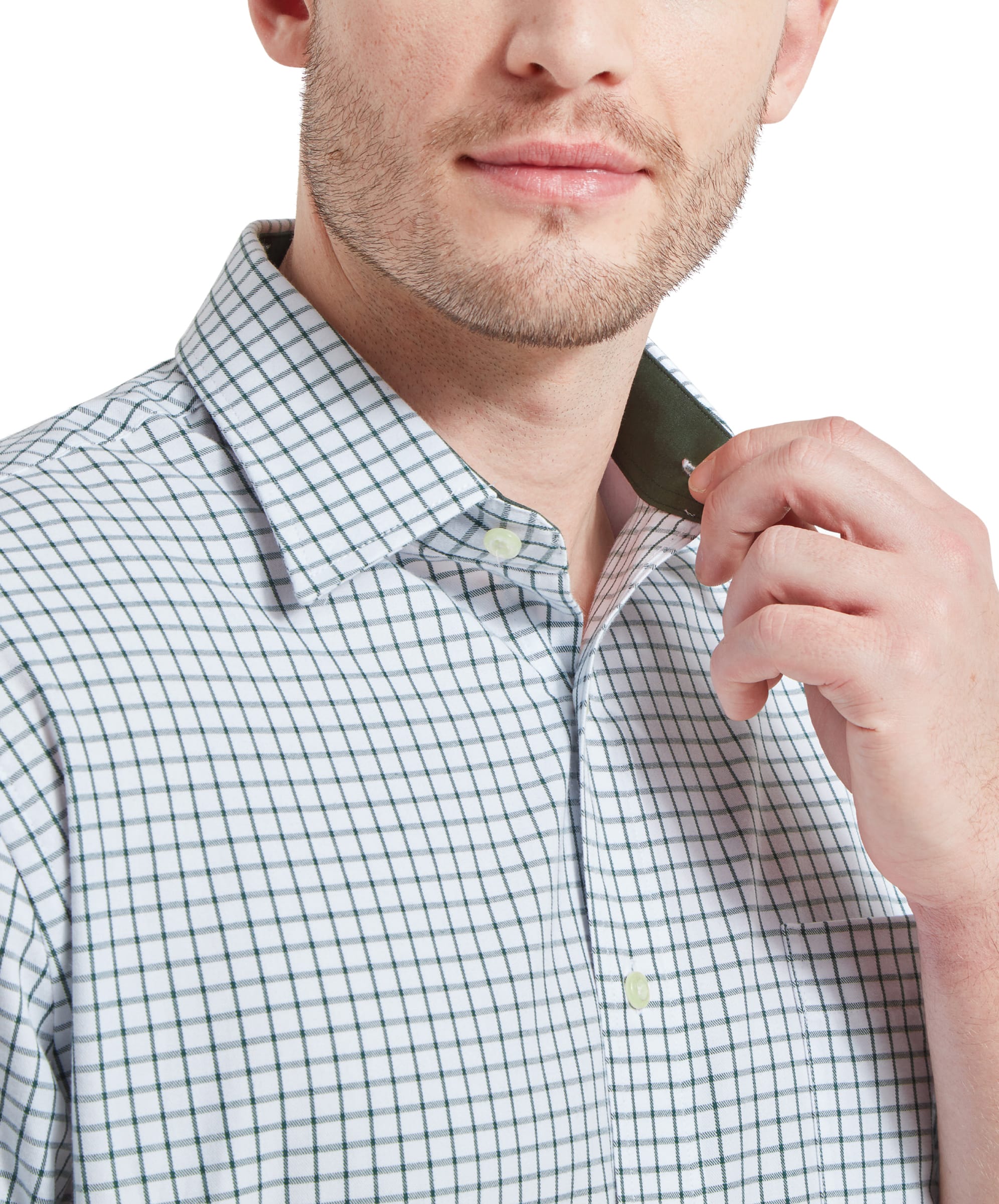 Close-up of the man adjusting the collar of his Schöffel Cambridge Classic Shirt for Men in Green, highlighting the shirt's collar detail.