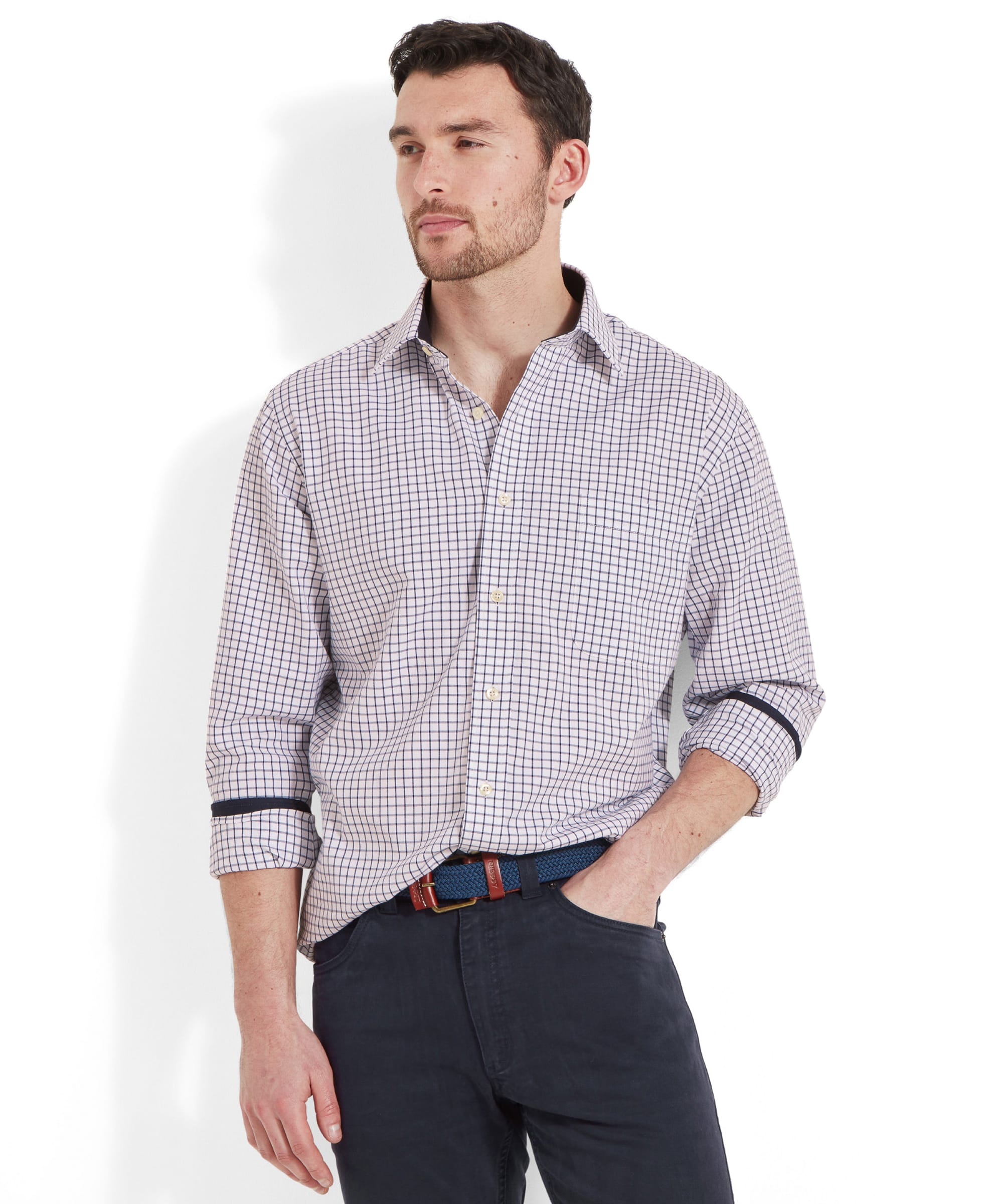 A man modeling the Schöffel Cambridge Classic Shirt for Men in Navy, standing with hands in pockets, wearing dark trousers.