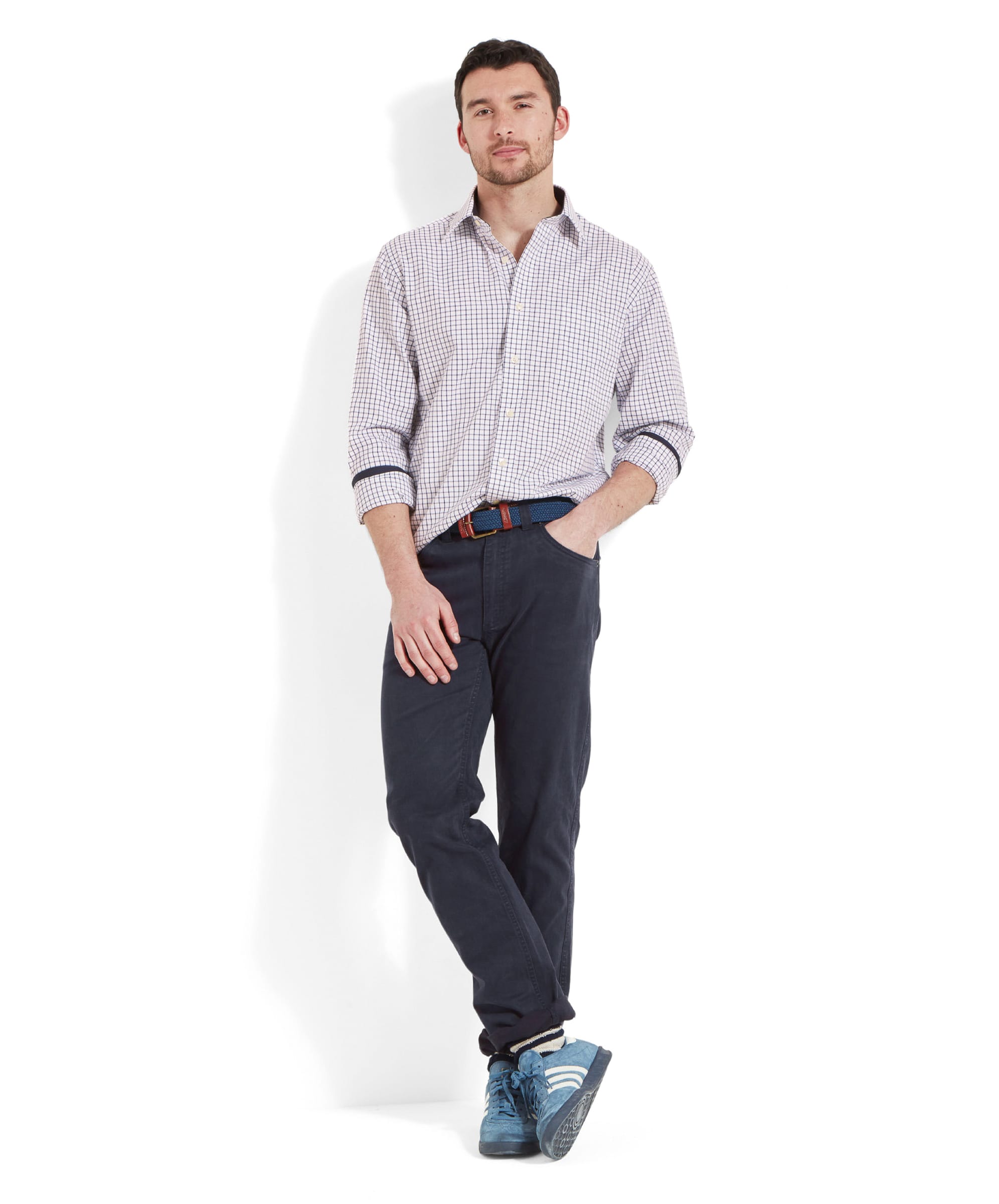 Full-body view of the model wearing the Schöffel Cambridge Classic Shirt for Men in Navy, paired with dark trousers and blue trainers.