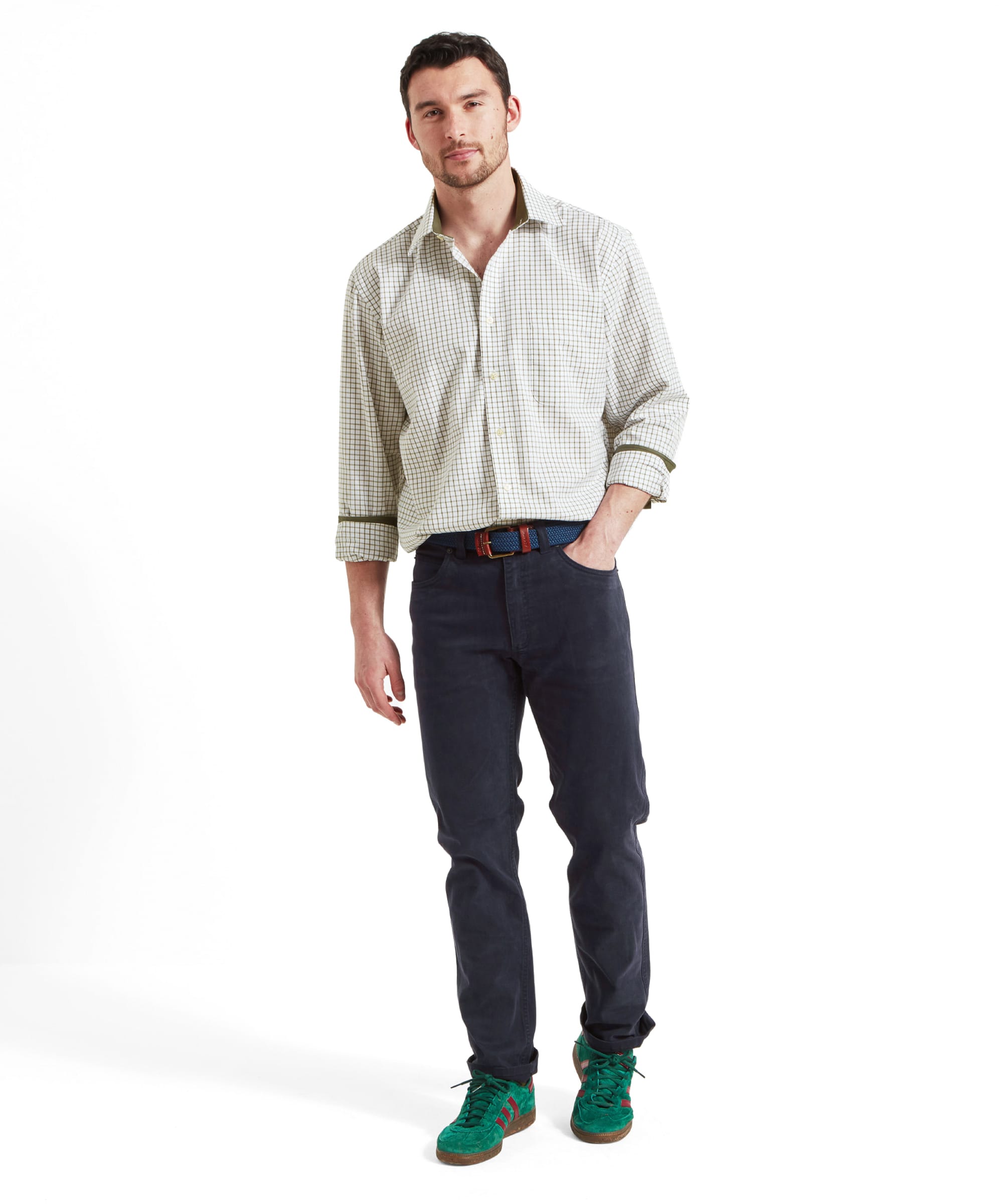 Full-body view of the model showcasing the Schöffel Cambridge Classic Shirt for Men in Green, paired with navy trousers and green trainers.