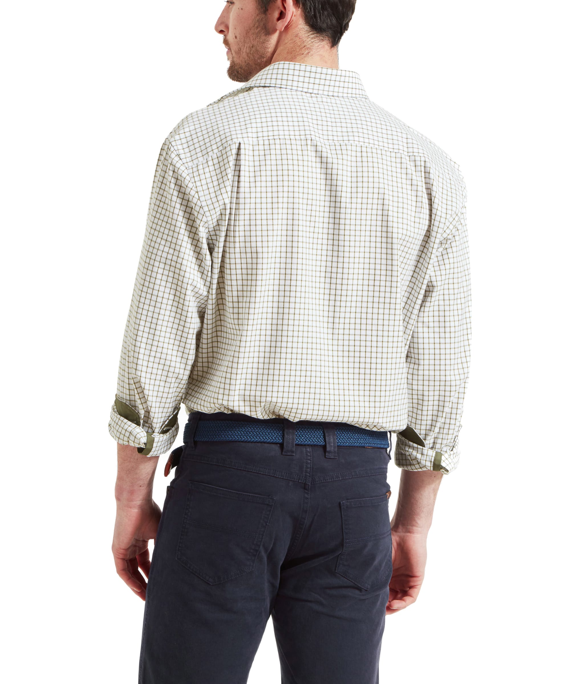 Rear view of the model highlighting the back design of the Schöffel Cambridge Classic Shirt for Men in Green, tucked into navy trousers.