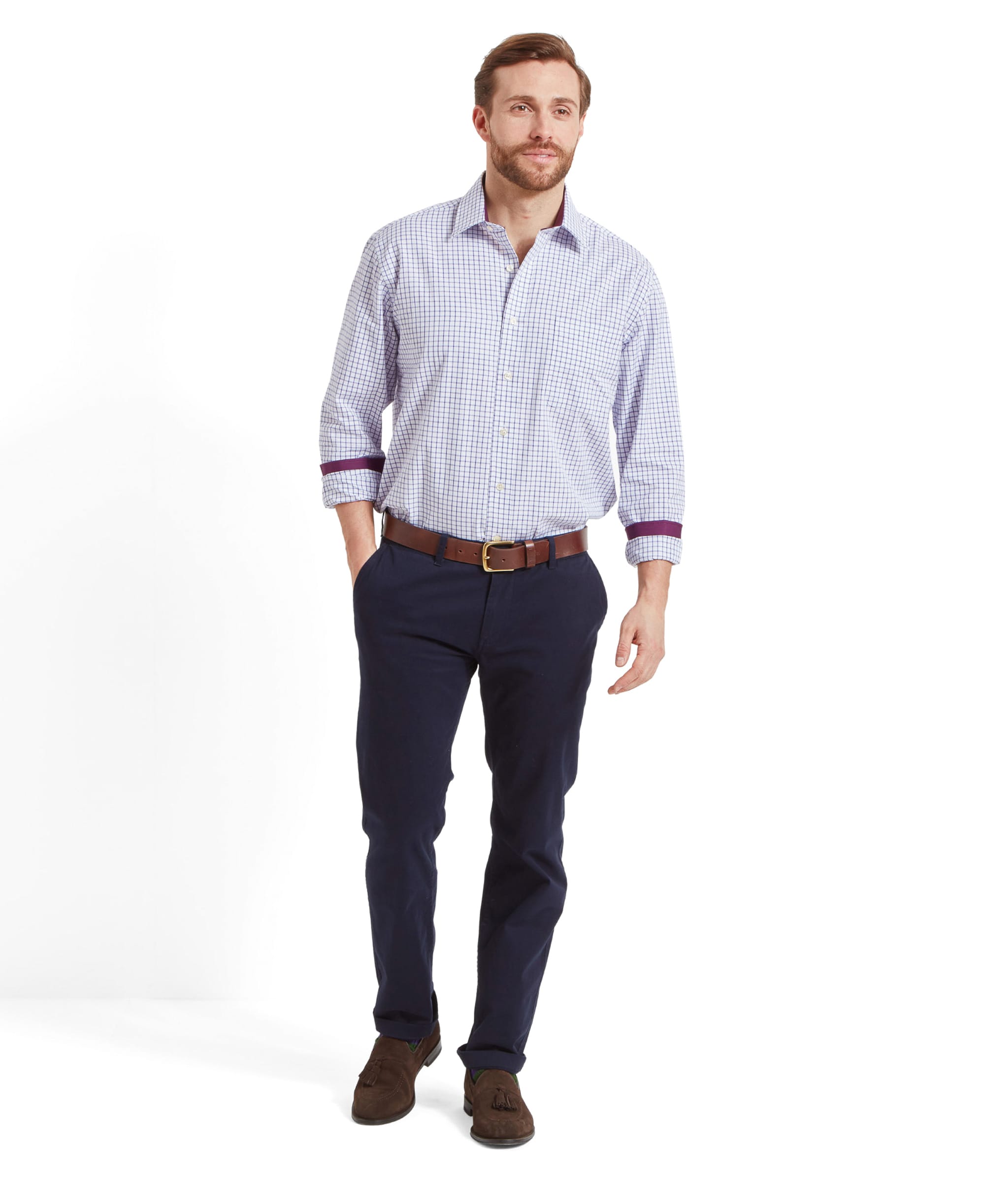 The same man is shown in a full body shot, standing and looking to the side, showcasing the Schöffel Cambridge Classic Shirt for Men in Purple paired with navy trousers and brown shoes.