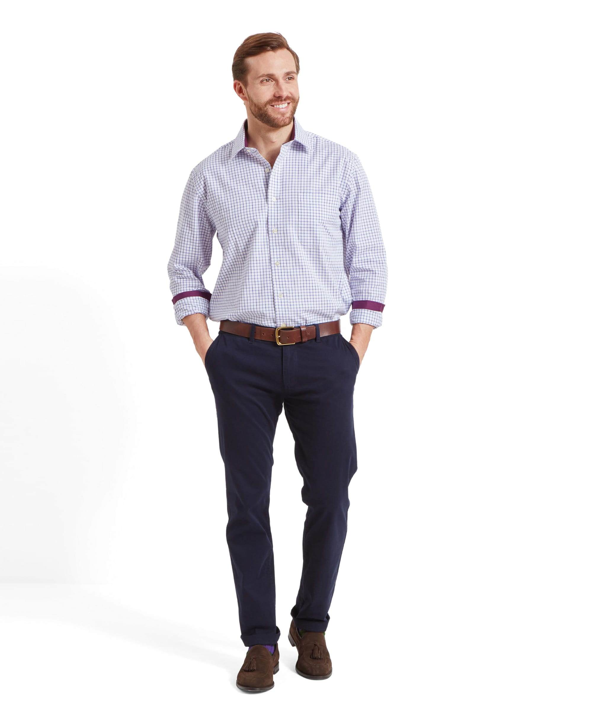 The man is walking towards the camera, smiling, with his hands in his pockets, emphasizing the casual yet elegant style of the Schöffel Cambridge Classic Shirt for Men in Purple.