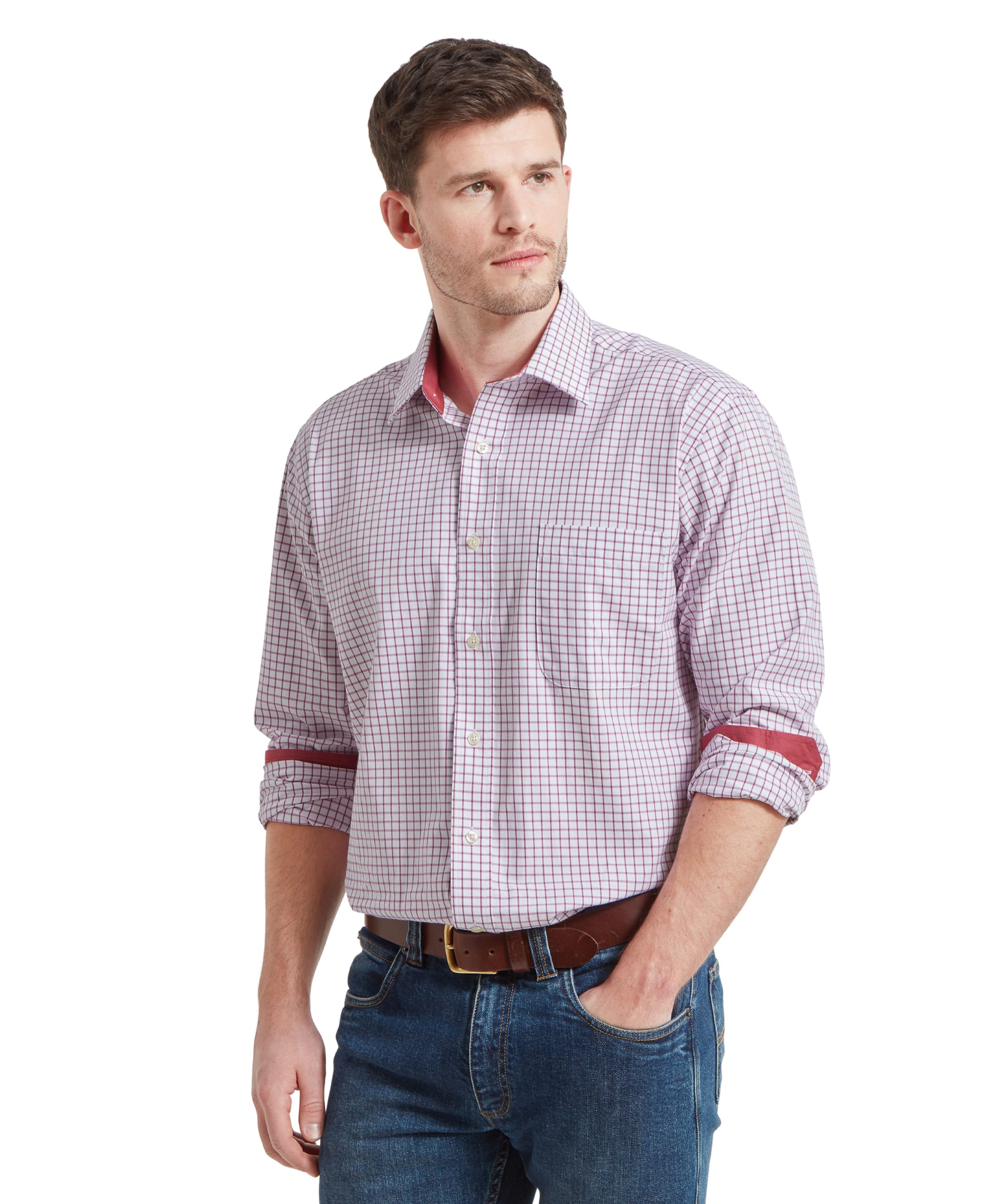 A model showcasing the Schöffel Cambridge Classic Shirt for Men in Red, standing with hands in pockets, highlighting the comfortable fit and stylish design.