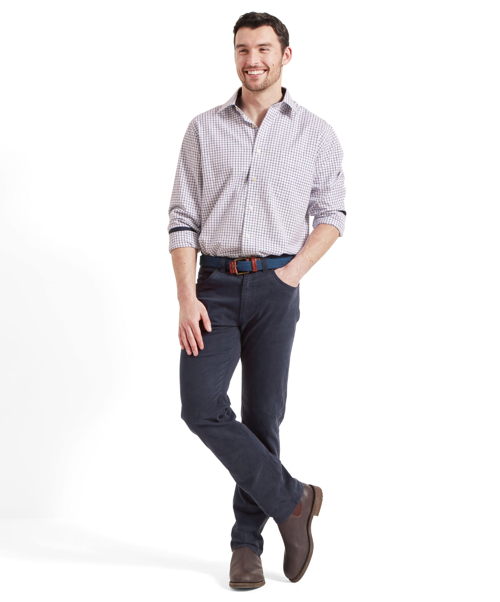 Full front view of the model in the Schöffel Canterbury 5 Pocket Jean for Men in Navy, paired with a plaid shirt and brown shoes.