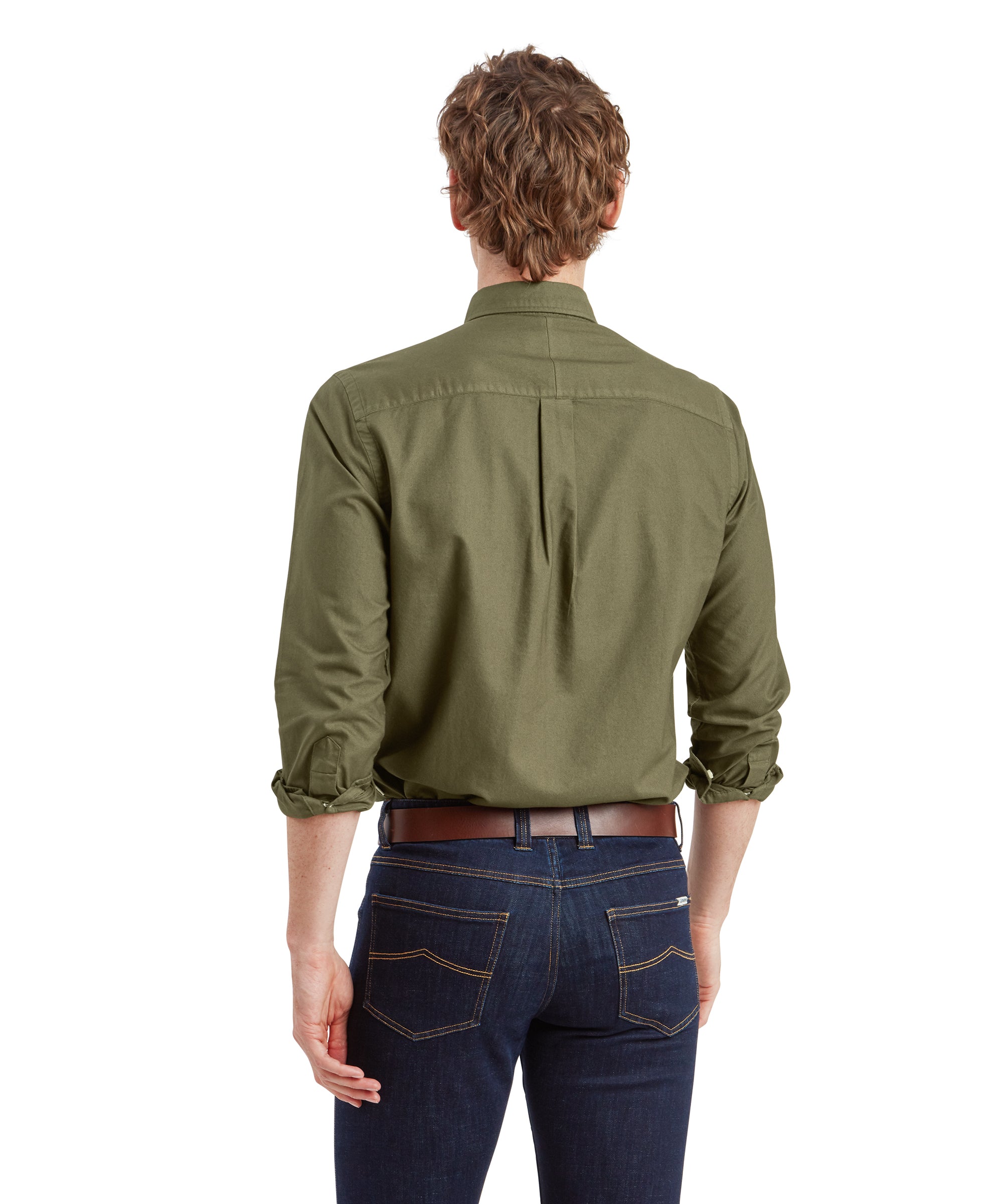 A back view of the male model, showing the Schöffel Cavendish Oxford Shirt for Men in Green from behind. The shirt has a central pleat and is tucked into dark blue jeans, which have two back pockets with yellow stitching. The brown leather belt is clearly visible.