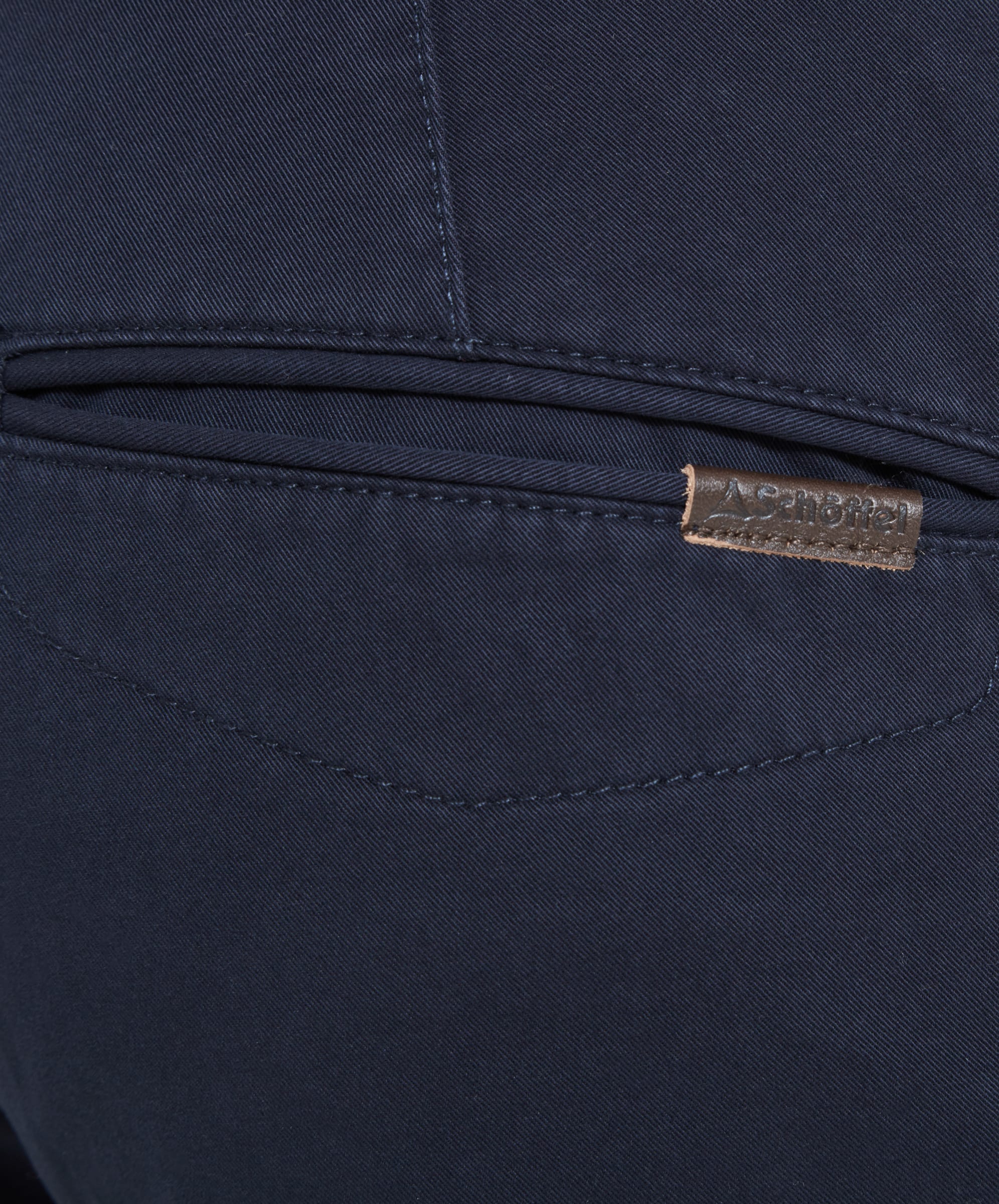 A close-up of the back pocket of the Schöffel Chichester Chino in Navy, showing the logo and fabric detail.