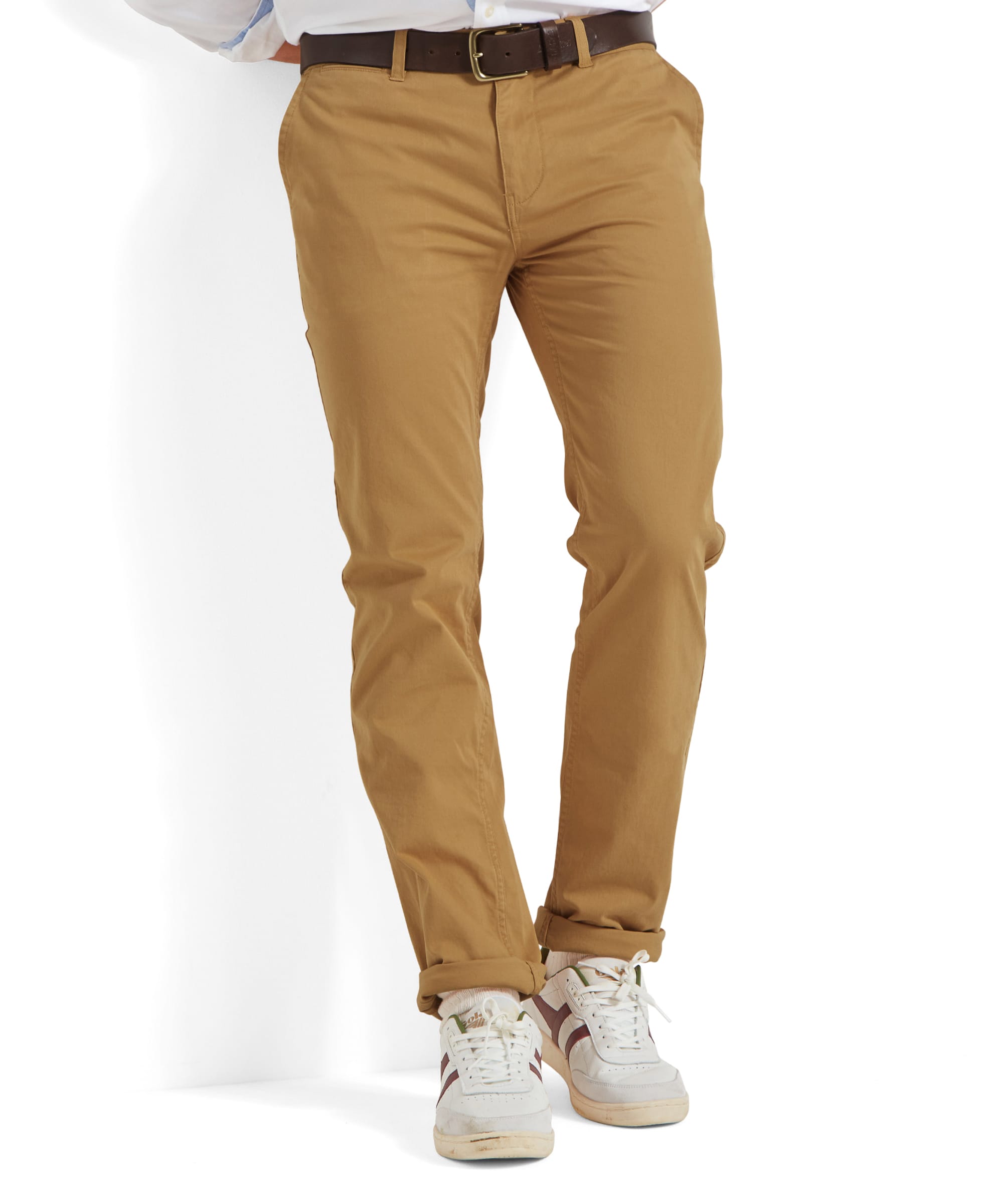 The model is wearing the Schöffel Chichester Chino in yellow, paired with a white shirt and white trainers for a fresh, casual look.