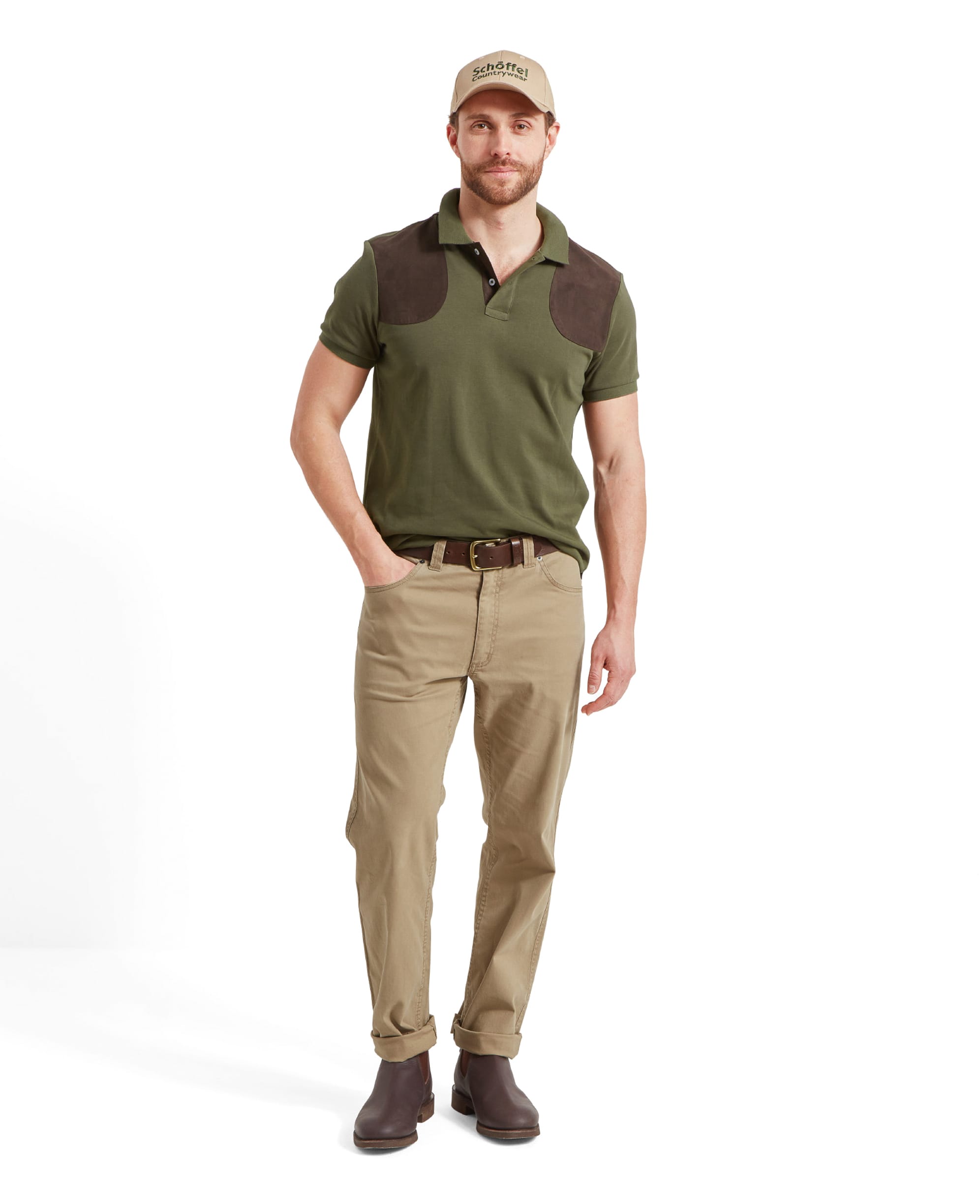 A full-body shot of a man in the Schöffel Cordoba Polo Shirt for Men in Green, paired with khaki pants and brown shoes.