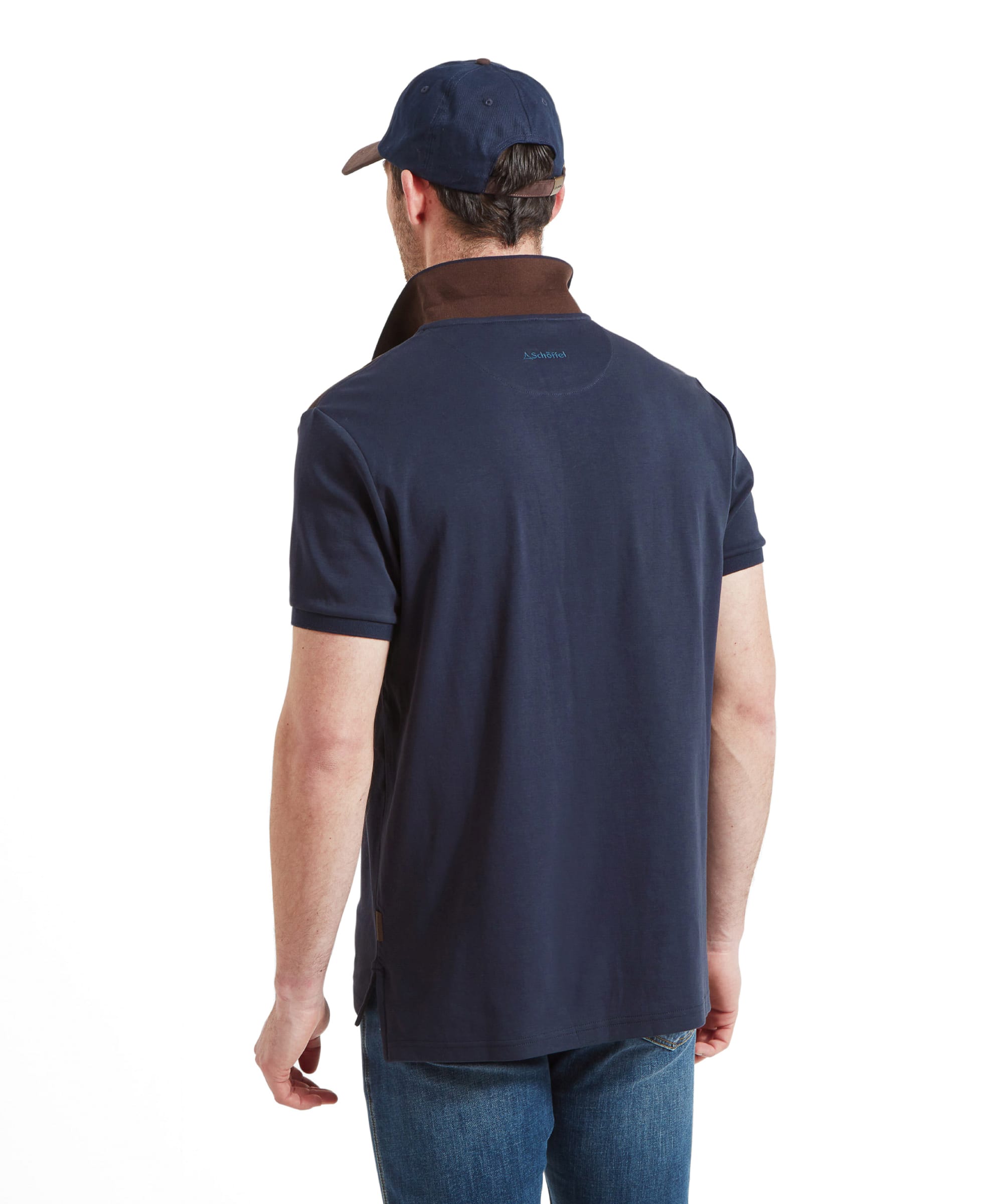 Back view of a man in a Schöffel Cordoba Polo Shirt for Men in Navy with brown shoulder patches, showing the back design and fit.