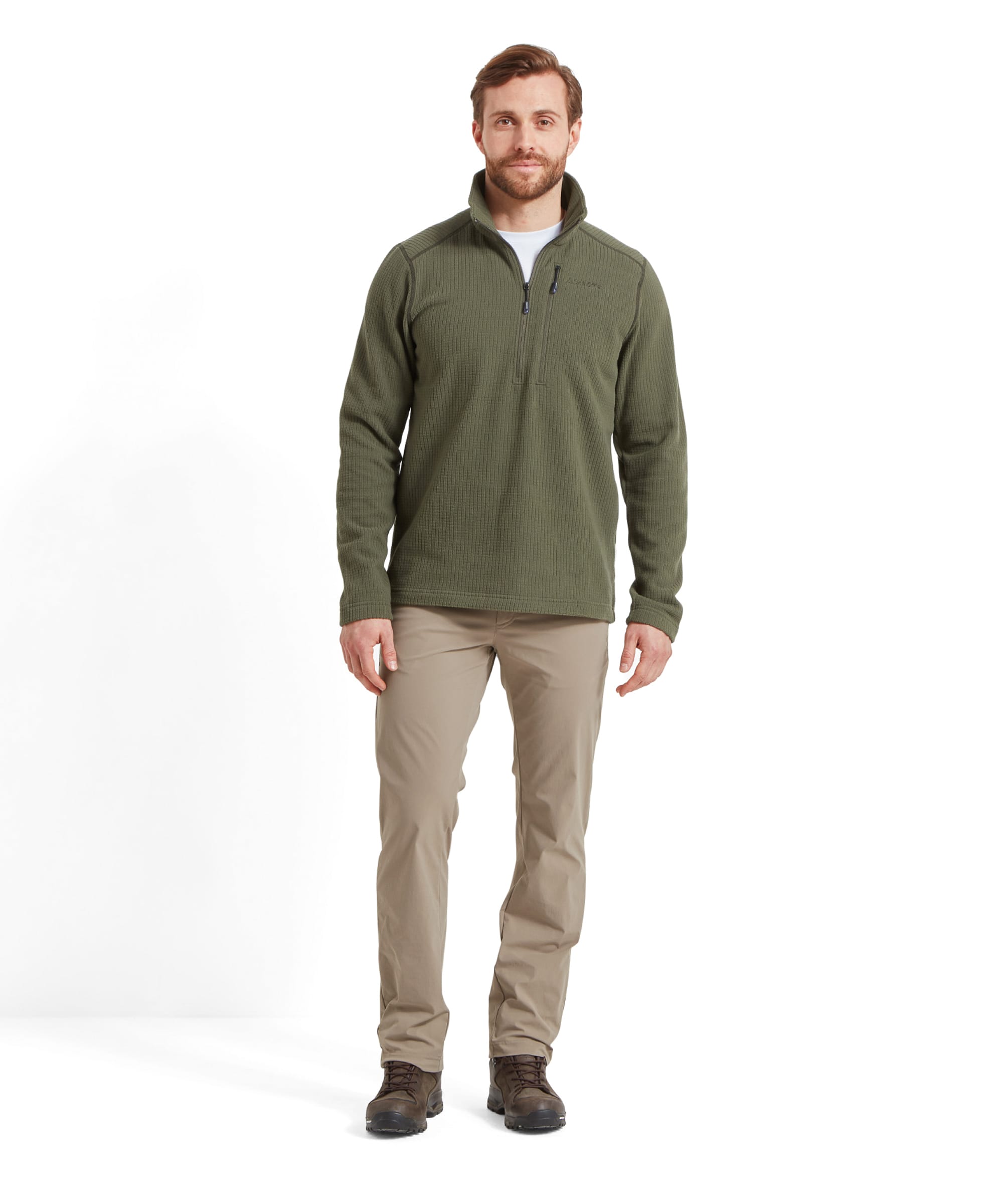 Full body shot of a man in Schöffel Men's Deveron Fly Fishing Trousers in Light Brown, highlighting the outdoor-ready ensemble with a green pullover.