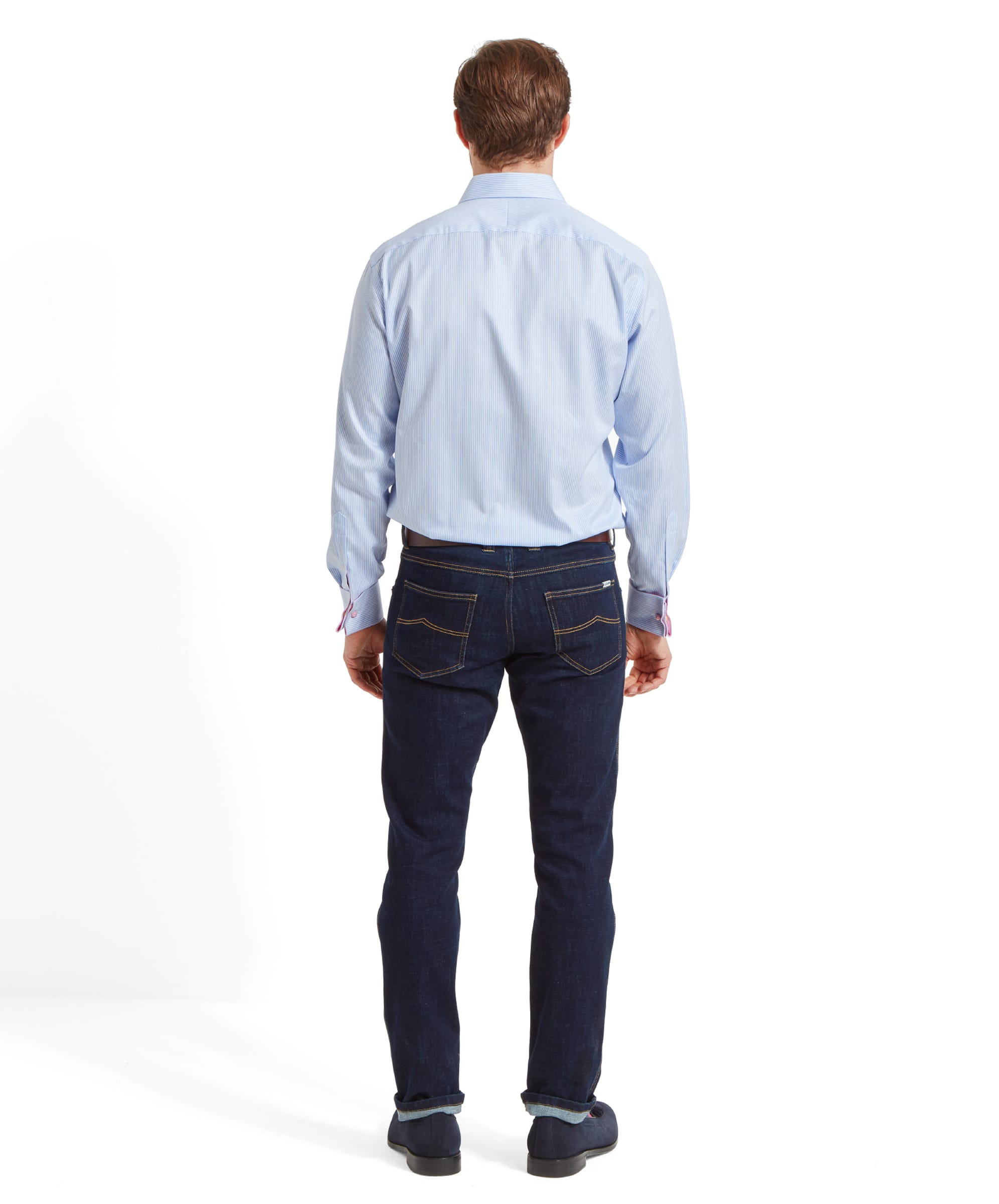 A back view of a man wearing a Schöffel Greenwich Tailored Shirt for Men in Blue Stripe, showing the fit of the shirt. He is also wearing dark blue jeans.